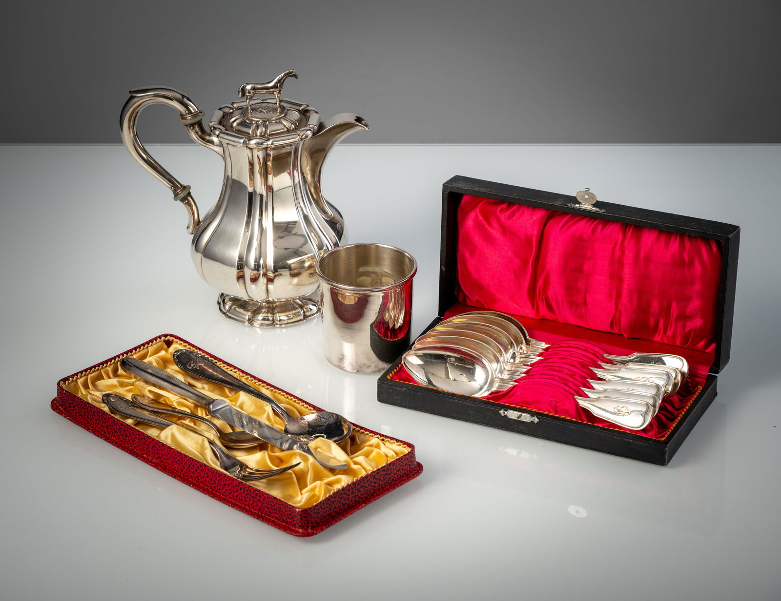 A COFFEE POT; CUTLERY PIECES AND A BEAKER: A COFFEE POT; CUTLERY PIECES AND A BEAKER 20th century H. 8-22 cm Silver coffee pot, hallmarked with the number “12” and an indistinct maker's mark, 6 spoons by Bruckmann and Söhne,