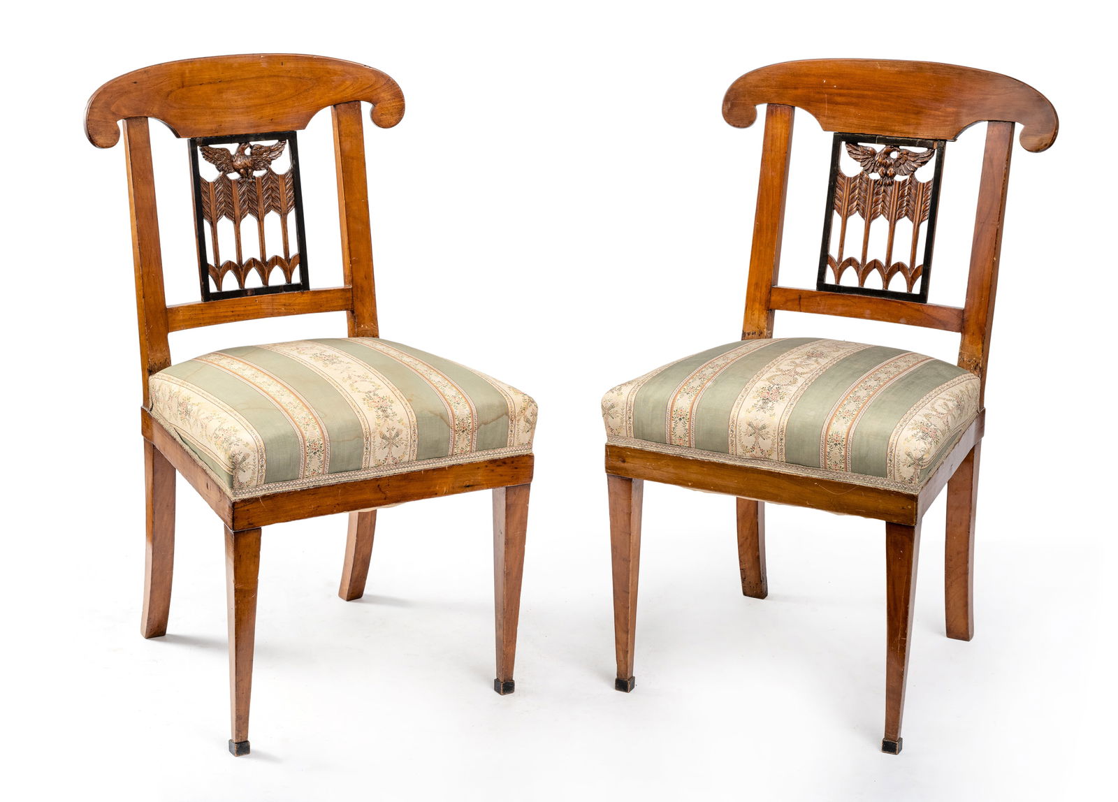 A PAIR OF BIEDERMEIER CHERRYWOOD CHAIRS: A PAIR OF BIEDERMEIER CHERRYWOOD CHAIRS circa 1820 H. 86 cm Partly ebonized and carved with eagles and arrows. Rest., damages due to age.Paar Biedermeier-Stühle mit Adlermotiv um 1820 H. 86 cm