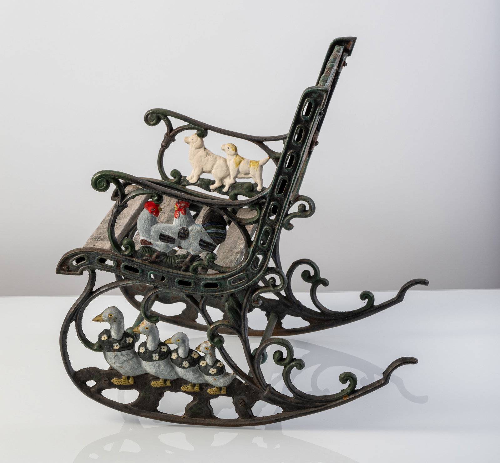 A CAST IRON KIDS' ROCKING CHAIR - 5