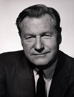 Nelson A Rockefeller: In this 1963 portrait by Philippe Halsman, Nelson A. Rockefeller is captured with commanding presence and a distinctly stern expression. Dressed in a dark suit, eyes fixed and jaw set, Rockefeller exu
