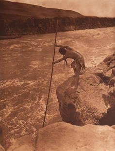 The Fisherman - Wishham: A majestic and atmospheric image capturing a Wishham man fishing from a precarious platform over the Columbia River. With his net extended and body poised in concentration, the fisherman becomes part