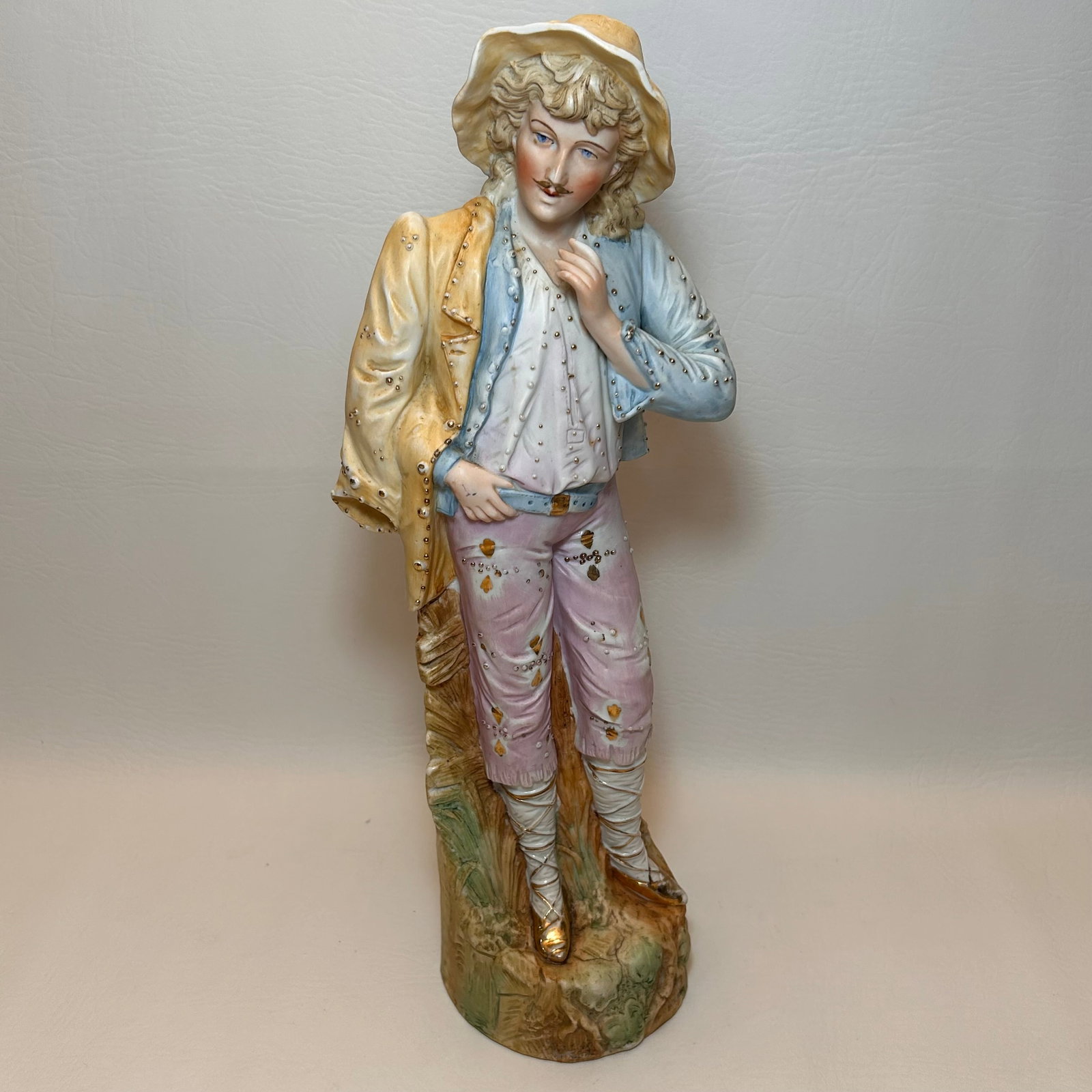 German Bisque Male Figurine 18th Century Style Pastel Colors with Gold Accent: W5.25in H14.5 D4.25