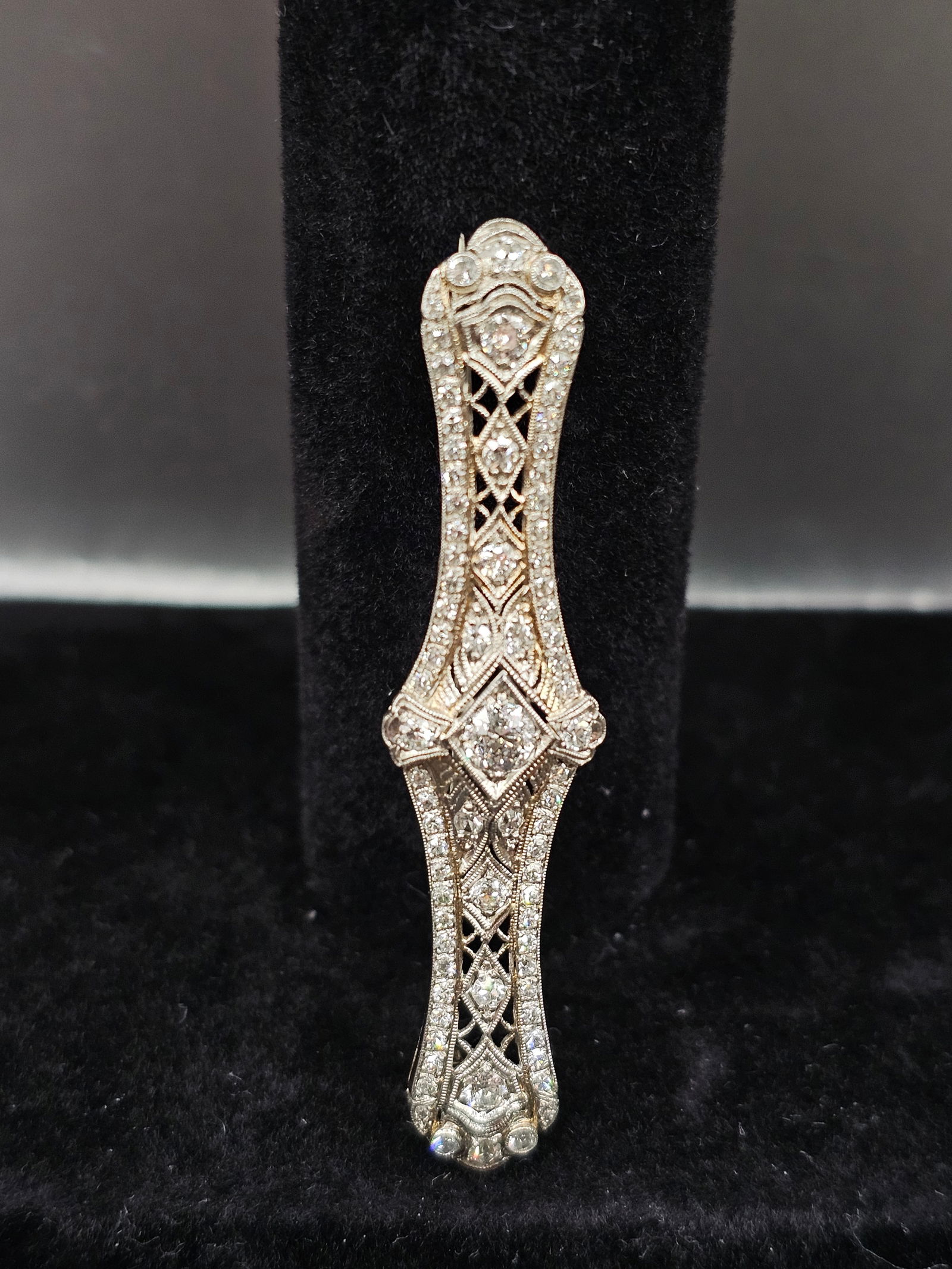 Platinum Art Deco Bar Brooch with Diamonds: Stones: European-cut diamond weighing approximately 0.30 carat; European and single-cut diamonds weighing a total of approximately 0.80 caratMetal: PlatinumGross Weight: 6.30 gramsDimensions: 2-1/4