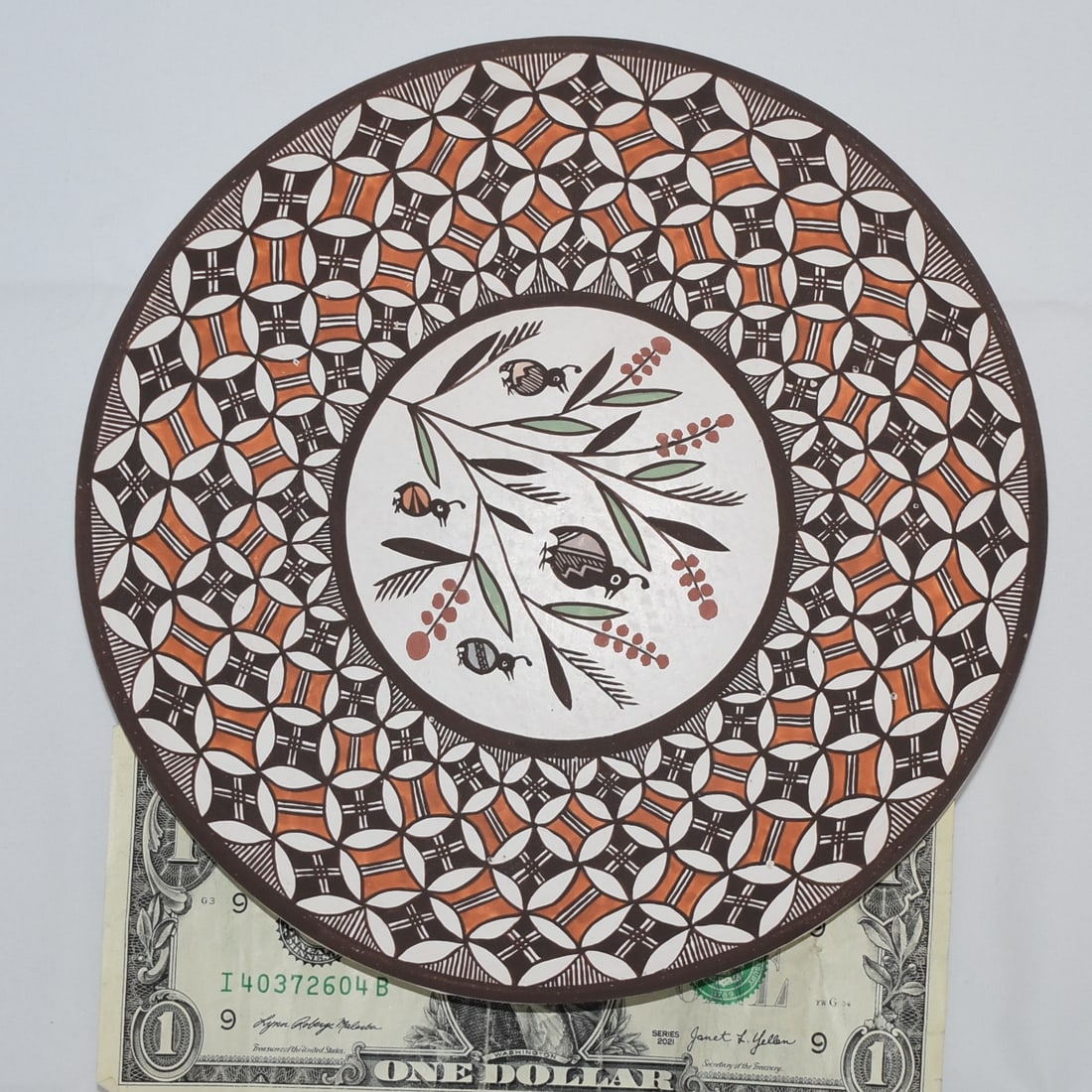 REBECCA LUCARIO (ACOMA) PLATE: A Rebecca Lucario (Acoma) Plate. Lucario is one of the finest Acoma fineline potters and painters, and she recently took Best in Show at the 2025 Heard Museum Indian Market. The birds in the center ar
