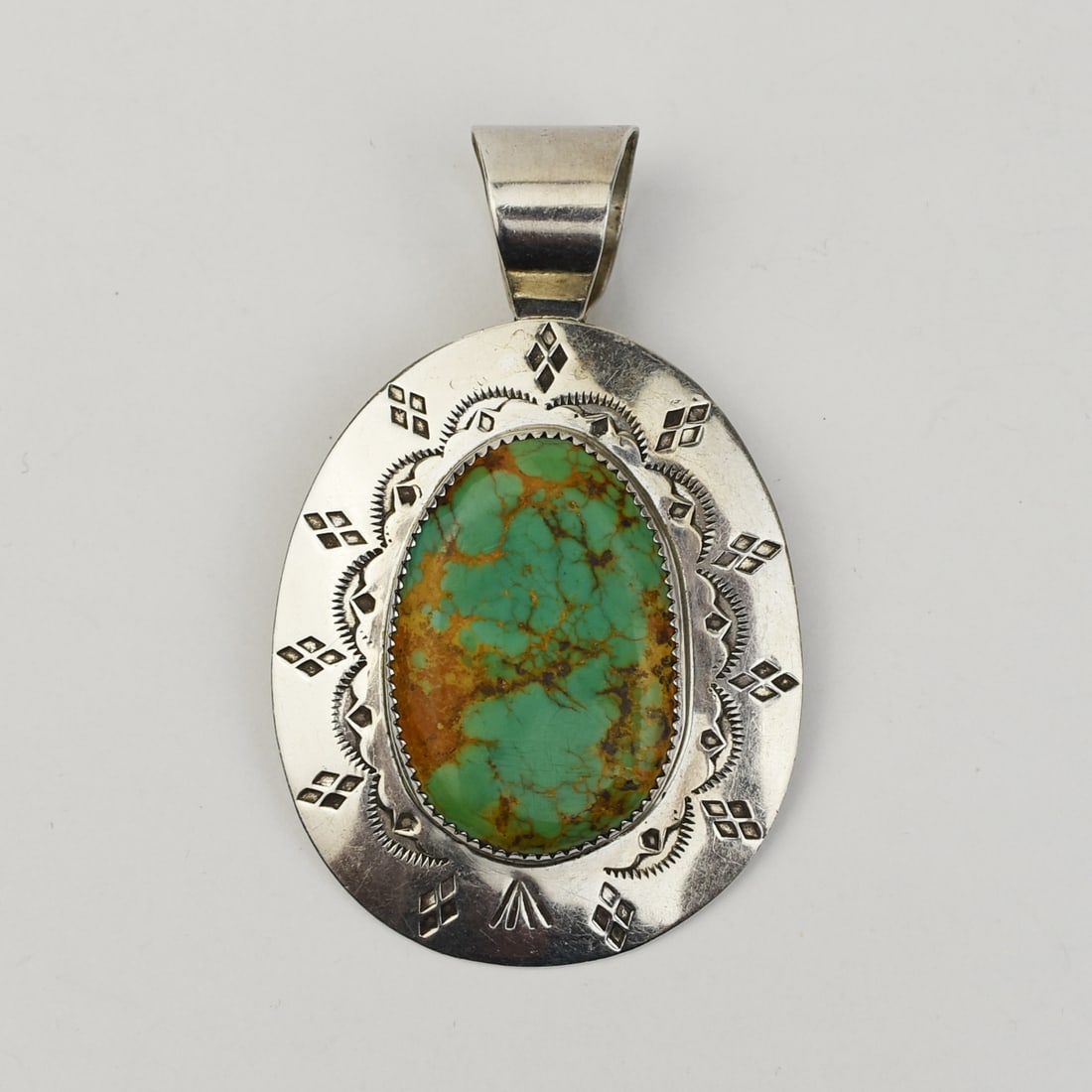 SANTO DOMINGO SILVER & ROYSTON TURQUOISE PENDANT, MARKED JLC: Santo Domingo silver and Royston turquoise pendant by Joe and LeJune Chavez HALLMARKS:JLC STERLING WEIGHT: 28 grams. DIMENSIONS: 1 7/8" x 2 7/8" including bail.