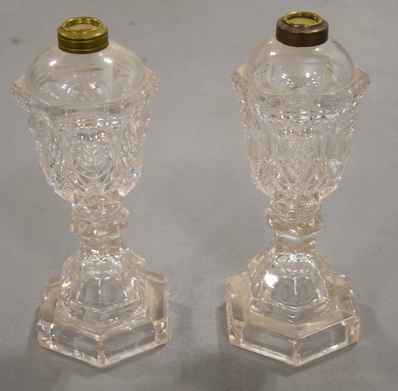 Pair Sandwich Flint Glass Fluid Lamps: 10 1/2" CLEAR GLASS LAMPS WITH HEART AND WAFFLE PATTERN- MISMATCHED COLLARS- WEAR AND IMPERFECTIONS