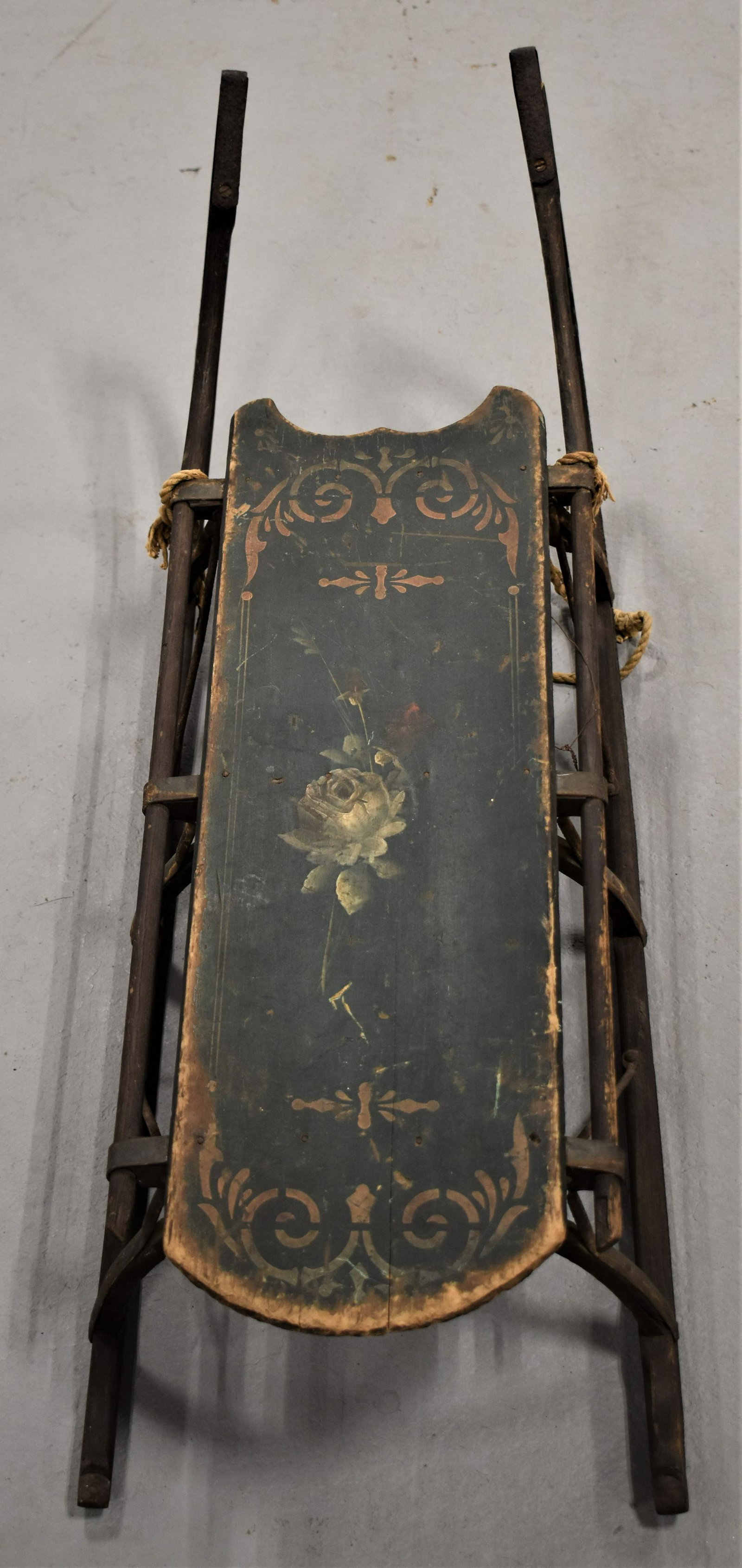 19th Century Painted Childs Wooden Sleigh: 19TH CENTURY PAINTED WOODEN CHILDS SLEIGH WITH GREEN PAINT AND FLORAL DECORATION WITH GOLD STENCILING- IRON RUNNERS- 32" LONG- WEAR, LOSSES, REPAIRS AND IMPERFECTIONS