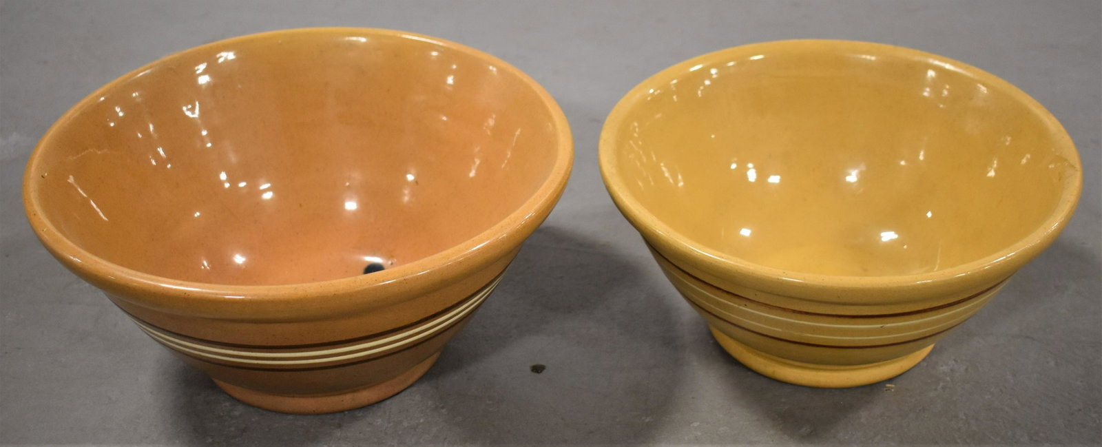 (2) Yellow Ware Banded Mixing Bowls: (2) LATE 19TH CENTURY YELLOW WARE MIXING BOWLS WITH BROWN AND WHITE BANDS - (1) 11 1/2"D X 5 1/4"T AND (1) 10 1/4"D X 4 3/4"T - WEAR AND IMPERFECTIONS