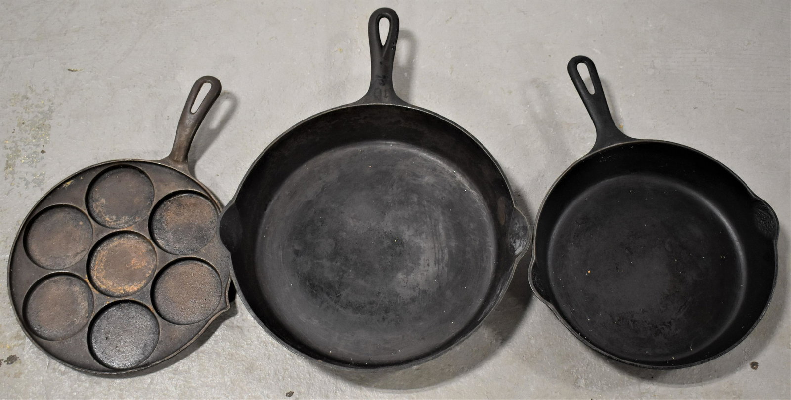 Lot (3) Cast Iron Griswold Pans: (3) GRISWOLD CAST IRON PANS - NO. 701 SKILLET , NO. 716B SKILLET AND NO. 34 PANCAKE SKILLET (PLETT SWEDISH) - IMPERFECTIONS