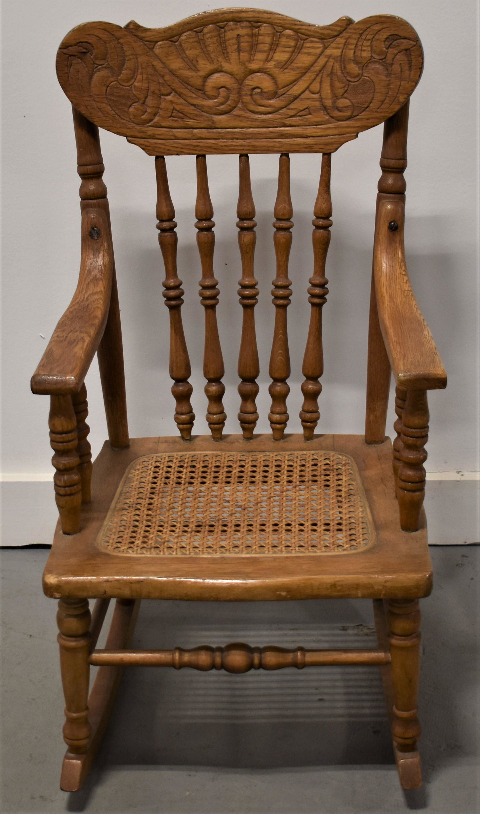 Child Oak Pressed Back Rocker: EARLY 20TH CENTURY CHILDS PRESSED BACK ROCKER WITH CANE SEAT - 26"T X 14"W X 22"D - WEAR AND IMPERFECTIONS