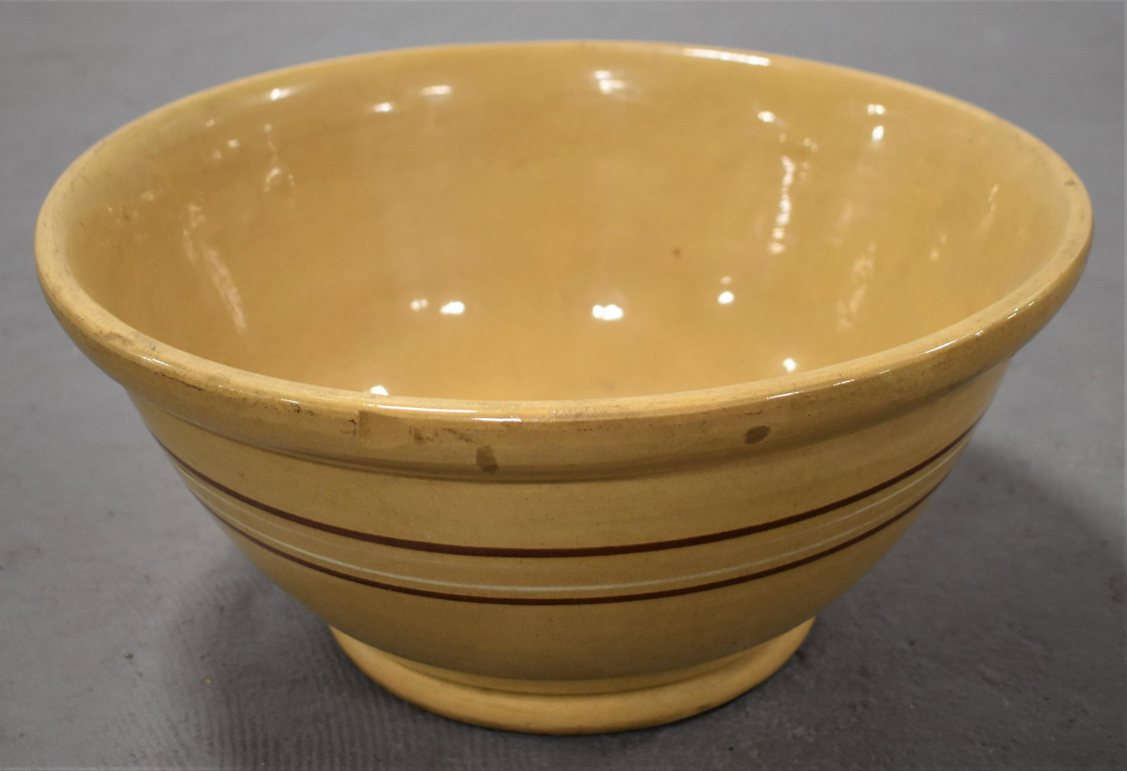 Large Yellow Ware Banded Mixing Bowl: 15" YELLOW WARE MIXING BOWL WITH BROWN AND WHITE BANDS - 15"D X 7"T - WEAR AND IMPERFECTIONS