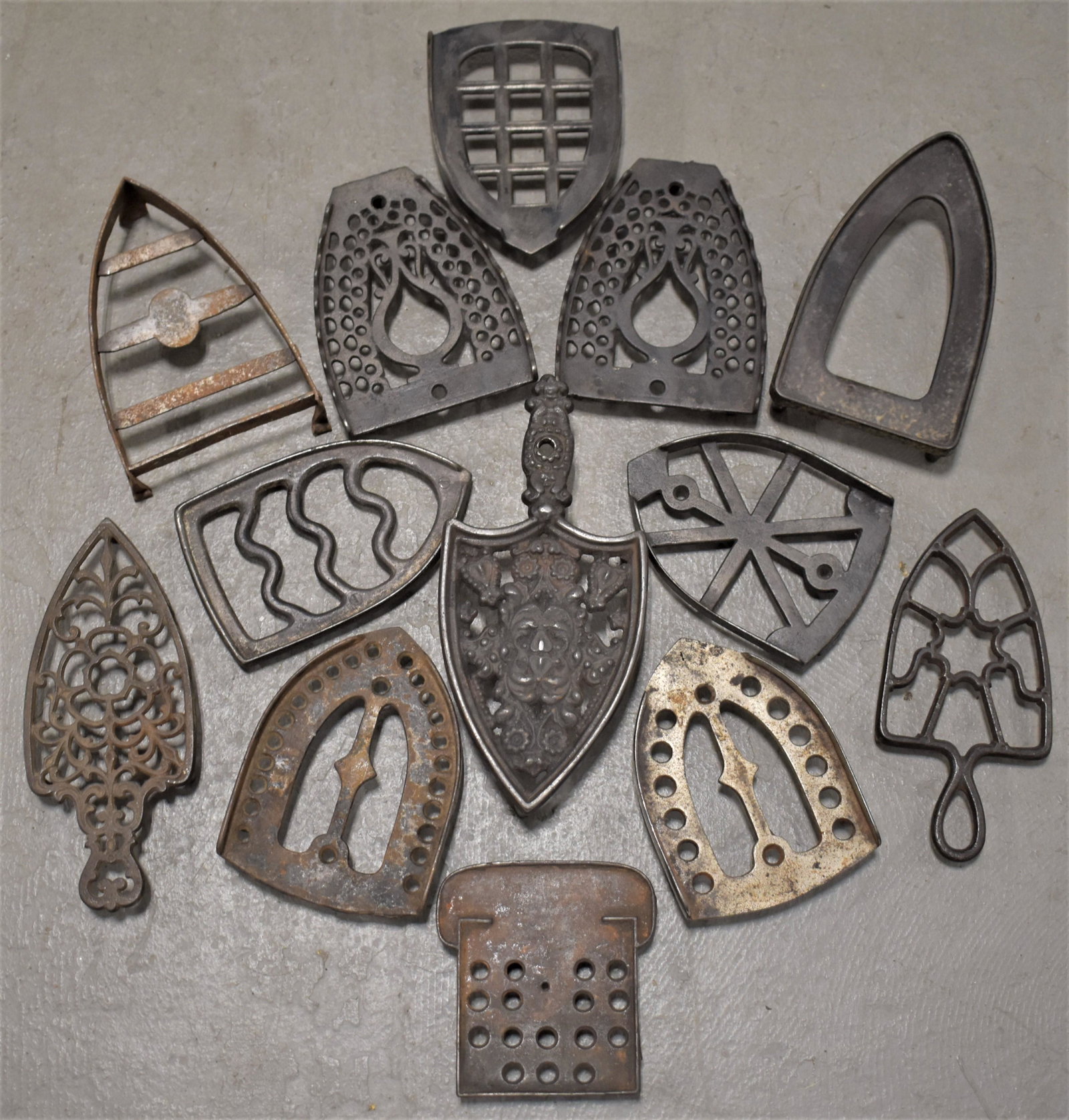 Lot (13) Cast Iron Trivets: LOT (13) MISC. VINTAGE CAST IRON TRIVETS - VARIOUS SIZES AND SHAPES - IMPERFECTIONS