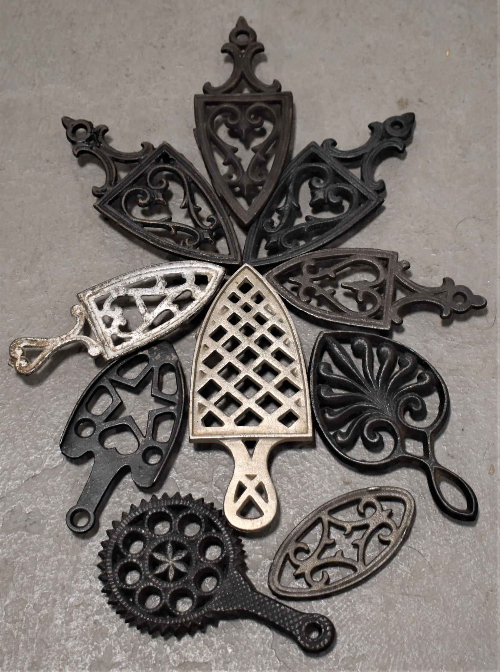 Lot (10) Miniature Cast Iron Trivets: LOT (10) MISC. VINTAGE CAST IRON TRIVETS - VARIOUS SIZES AND SHAPES - IMPERFECTIONS