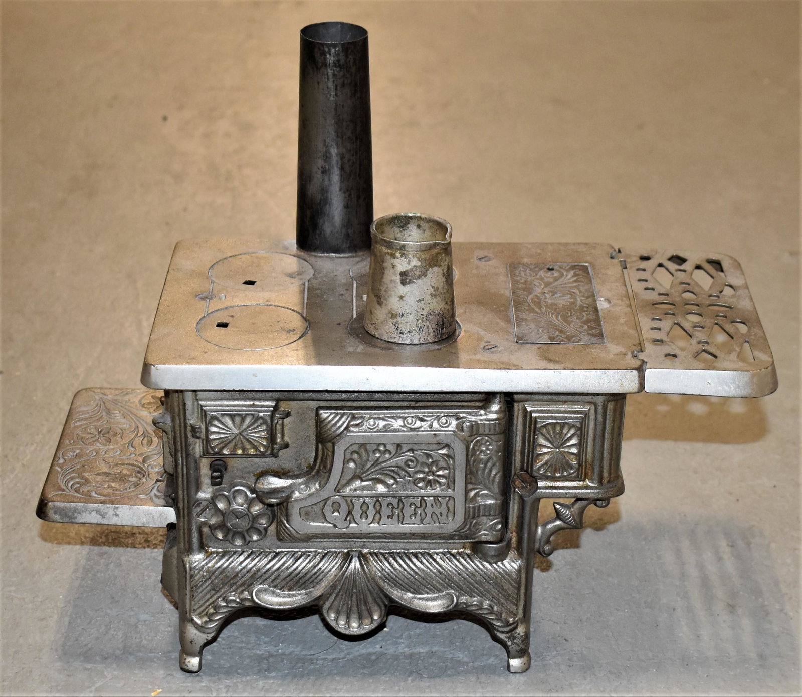 Nickel Salesman Sample Cast Iron Stove: EARLY 20TH CENTURY VINTAGE SALESMAN SAMPLE OR TOY STOVE - "QUEEN" WITH STOVE PIPE AND IRON PITCHER - 13"W X 6"D X 6 1/2"T (STOVE) 11"T WITH STOVE PIPE - IMPERFECTION