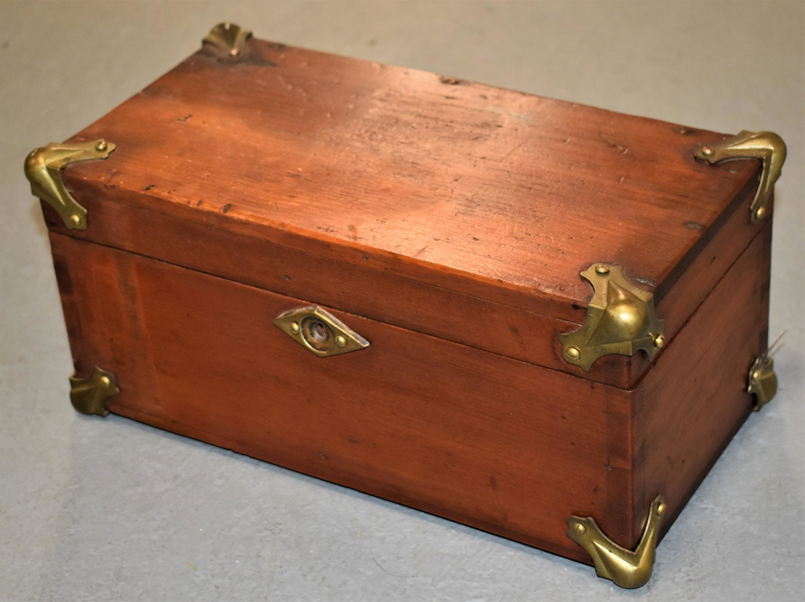 19th Century Pine Flat Top Document Box: 19TH CENTURY PINE FLAT TOP DOCUMENT BOX WITH DOVETAILED CONSTRUCTION WITH BRASS MOUNTED DECORATIVE CORNERS AND ESCUTCHEONS - 5"T x 11"W x 5 1/2"D - WEAR, IMPERFECTIONS - WRITING ON INTERIOR WITH MARKE