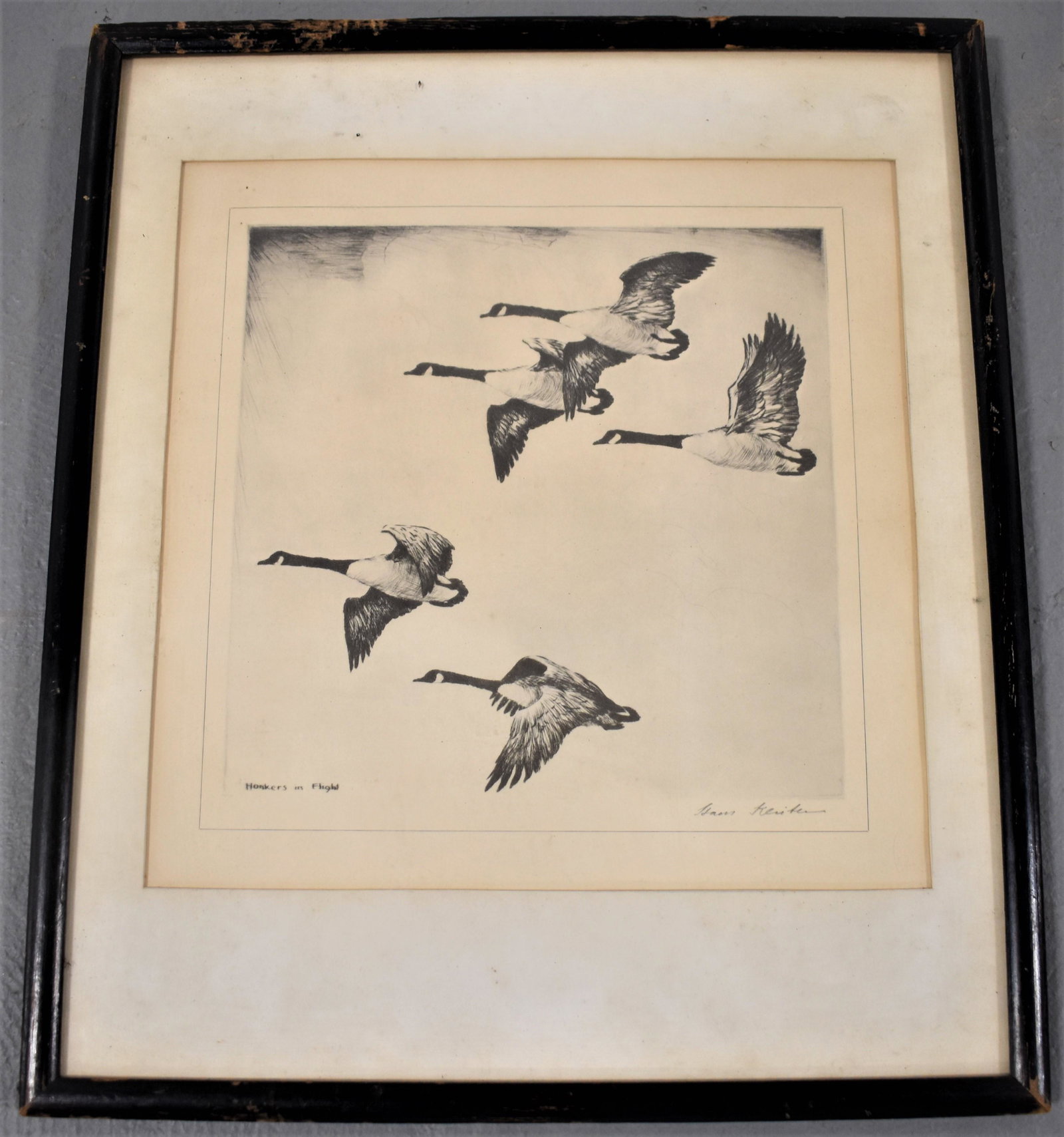 Hans Kleiber Etching of Geese in Flight: ETCHING OF GEESE IN FLIGHT TITLED "HONKERS IN FLIGHT" SIGNED LOWER RIGHT HANS KLEIBER - FRAMED AND MATTED - 10" X 10" SIGHT - TONING, FOXING, WEAR TO FRAME AND IMPERFECTIONS