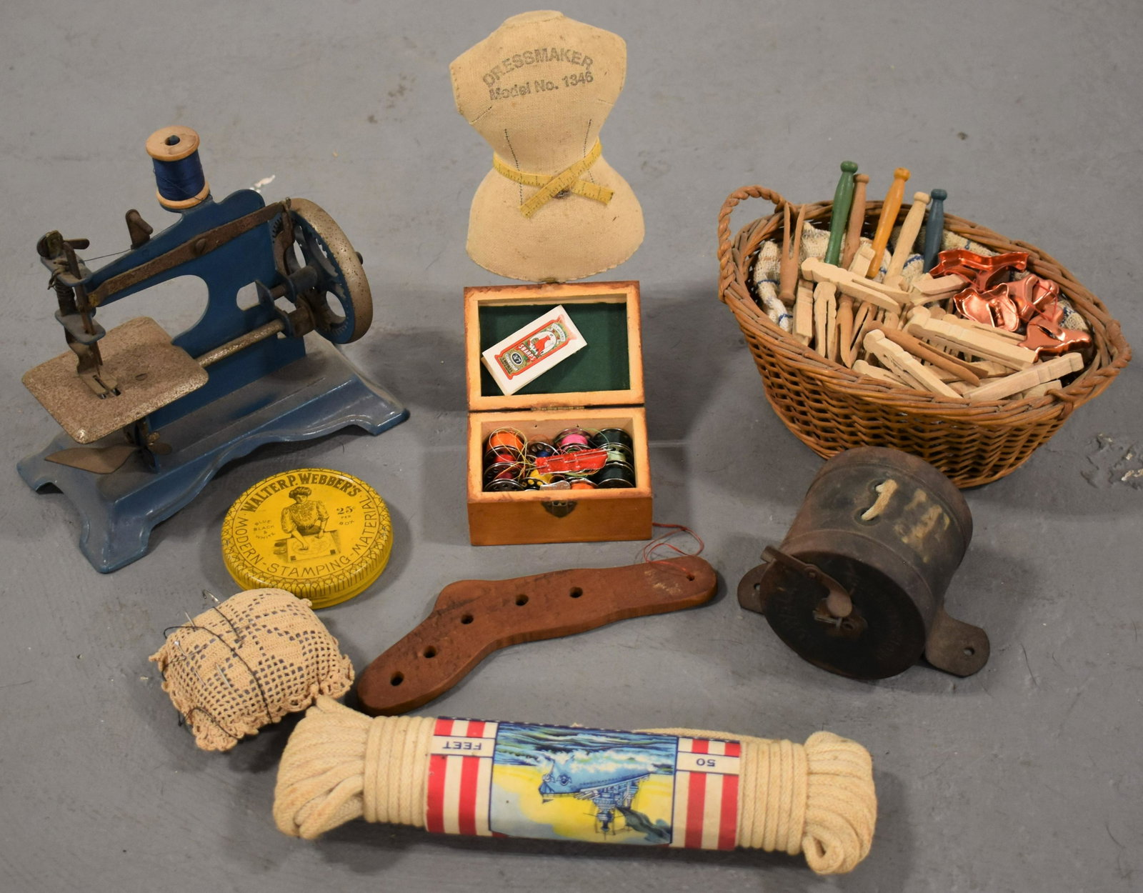 Lot Sewing and Country Store Items: LOT INCLUDES CHILDS SEWING MACHINE CLOTHES PINS, LOWELL CLOTHES LINE REEL, MINIATURE DRESS FORM AND SOCK STRETCHER, MAUCHLINE BOX ECT... - IMPERFECTIONS
