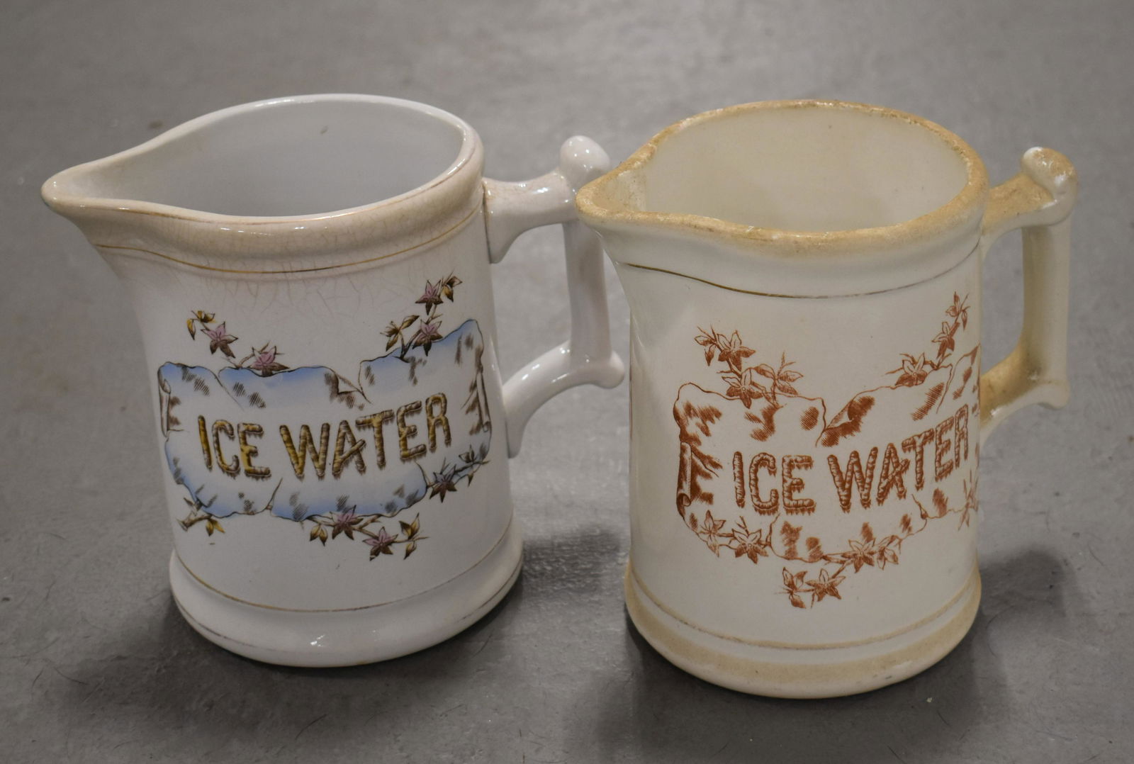 (2) White Ironstone Ice Cream Water Pitchers: (2) 6 3/4" VICTORIAN WHITE IRONSTONE PITCHERS - BOTH WITH TRANSFERS" ICE WATER" ON FRONT - ONE MARKED K. T. AND K GRANITE ON BOTTOM - WEAR AND IMPERFECTIONS