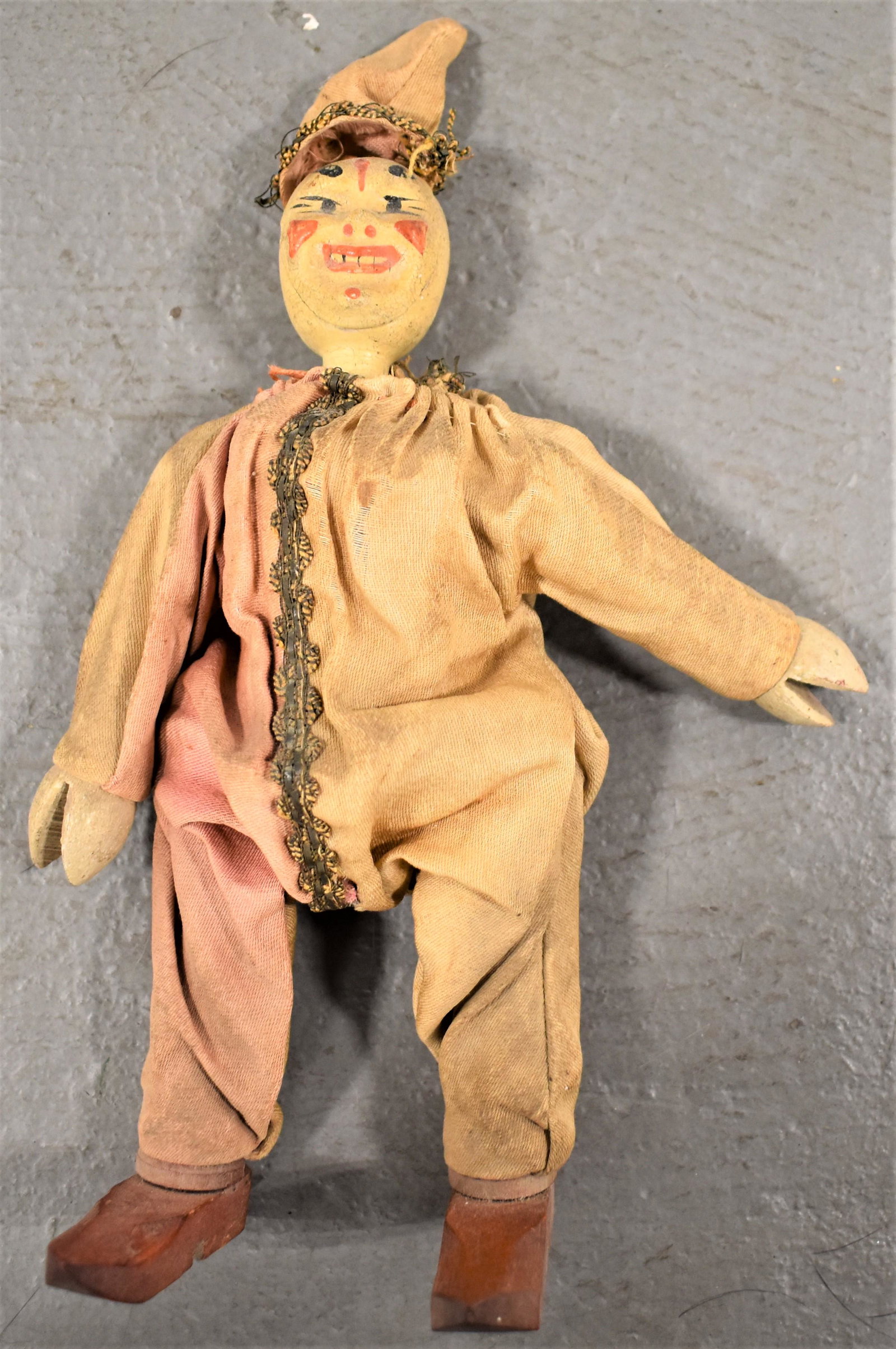 Schoenhut Clown: EARLY 20TH CENTURY VINTAGE SCHOENHUT CLOWN - JOINTED W/ WOODEN BODY W/ PAINTED FEATURES AND ORIGINAL CLOTHES - 9"T - WEAR, TONING TO CLOTHS AND IMPERFECTIONS