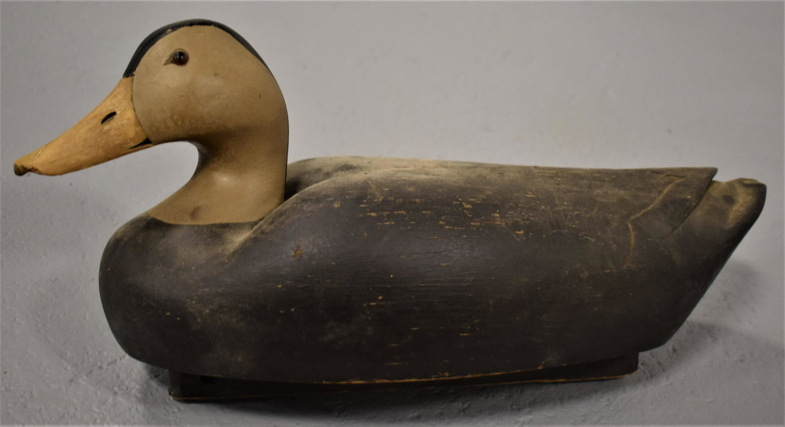 Vintage 20th Century Carved and Painted Duck Decoy: MID 20TH CENTURY CARVED AND PAINTED WOODEN DUCK DECOY- BLACK DUCK SINGED WITH C. E. S. BRAND ON BOTTOM 18 1/2"L - LOSSES TO TAIL AND BILL, WEAR AND IMPERFECTIONS