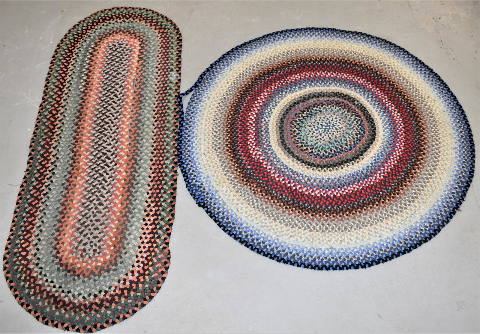 (2) Braided Area Rugs: (2) EARLY 20TH CENTURY BRAIDED AREA RUGS -(1) RUNNER 84 1/2" X 321/2" - WEAR, SPLITS AND IMPERFECTIONS (1) RUNNER 63"DIA - SPLITS, WEAR AND IMPERFECTIONS