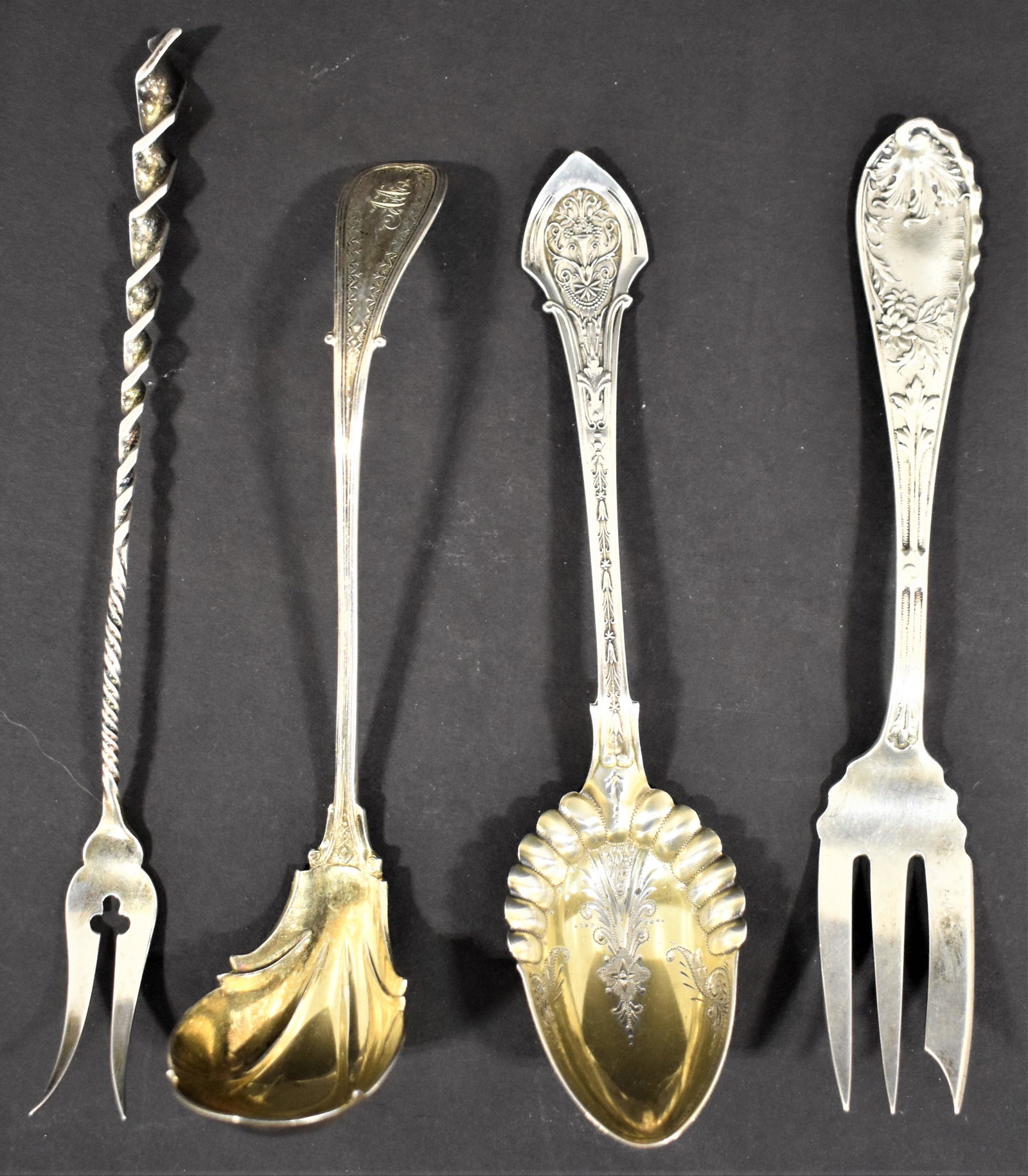 (4) Sterling Flatware Items: LOT (4) STERLING SERVING FLATWARE ITEMS (3) BY WOOD AND HUGHES - 5 7/8" FORK, 5 3/4" LADLE AND 5 3/4" SPOON TOGETHER WITH (1) TWISTED OLIVE FORK BY FRANK WHITING - 2.73 TROY OZ - WEAR AND IMPERFECTION