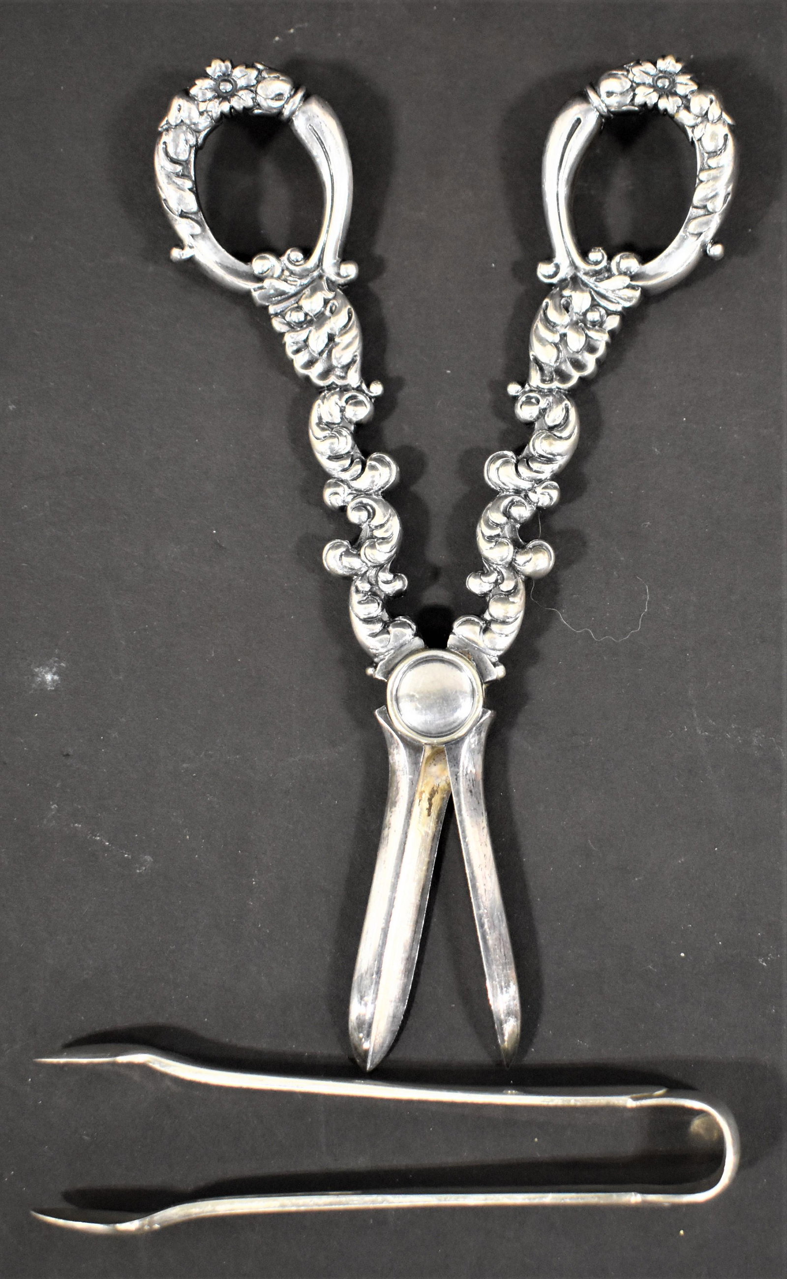 (2) Tiffany Silver Items: PAIR 4" TIFFANY SUGAR TONGS MARKED TIFFANY AND STERLING PAT 1912 M TOGETHER W/ PAIR 6' GRAPE SHEARS MARKED TIFFANY AND CO MAKERS 30N - 4.82 TROY OZ - WEAR AND IMPERFECTIONS