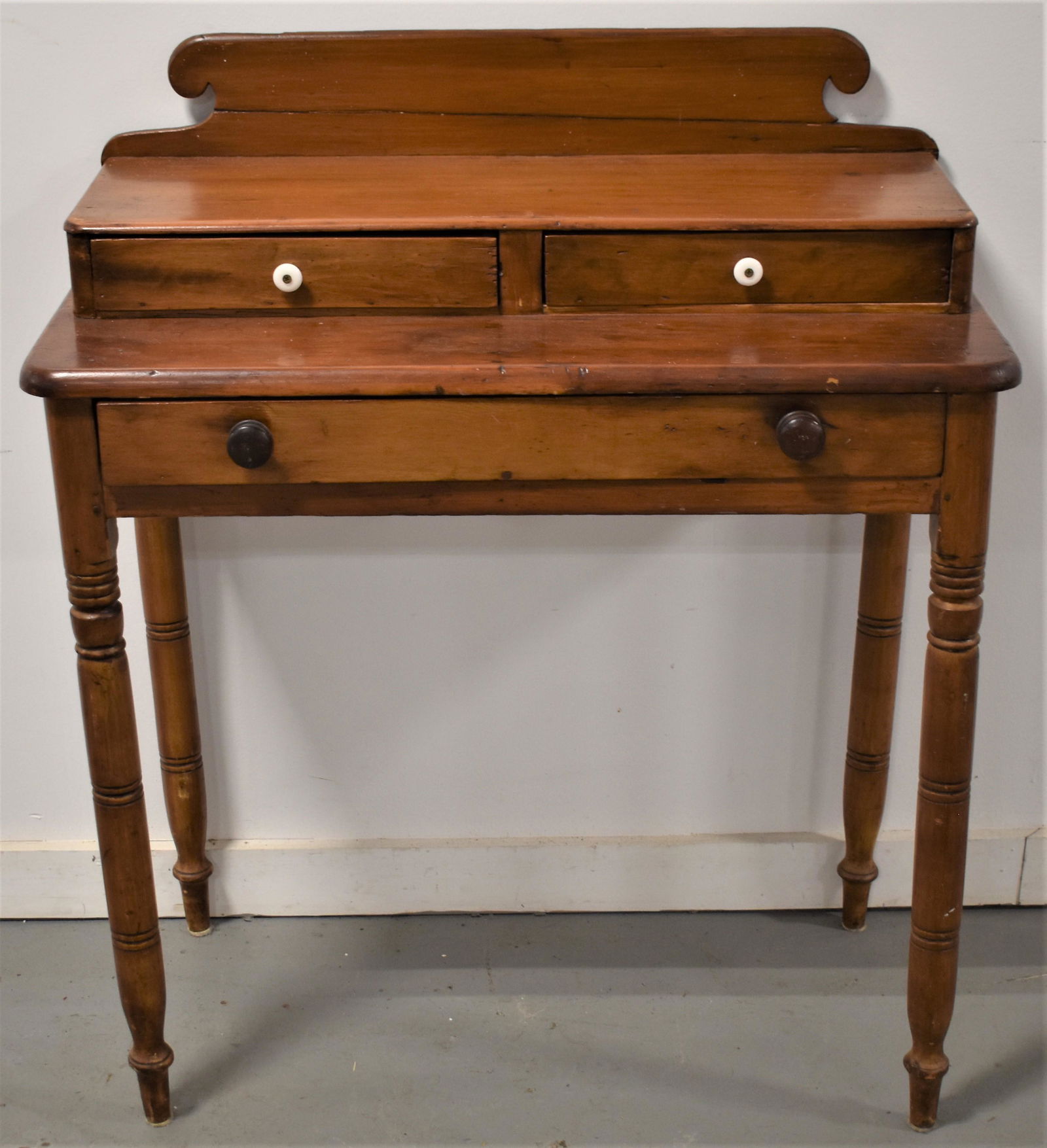 Sheraton Pine Dressing Table: 19TH CENTURY COUNTRY SHERATON PINE DRESSING TABLE W/ 2 DRAWER DECK TOP OVER SINGLE LONG DRAWER ON TURNED LEGS W/ SHAPED BACK SPLASH - 23"W X 16"D X 38 1/2"T - BACK SPLASH REPAIRED, WEAR AND IMPERFECTI