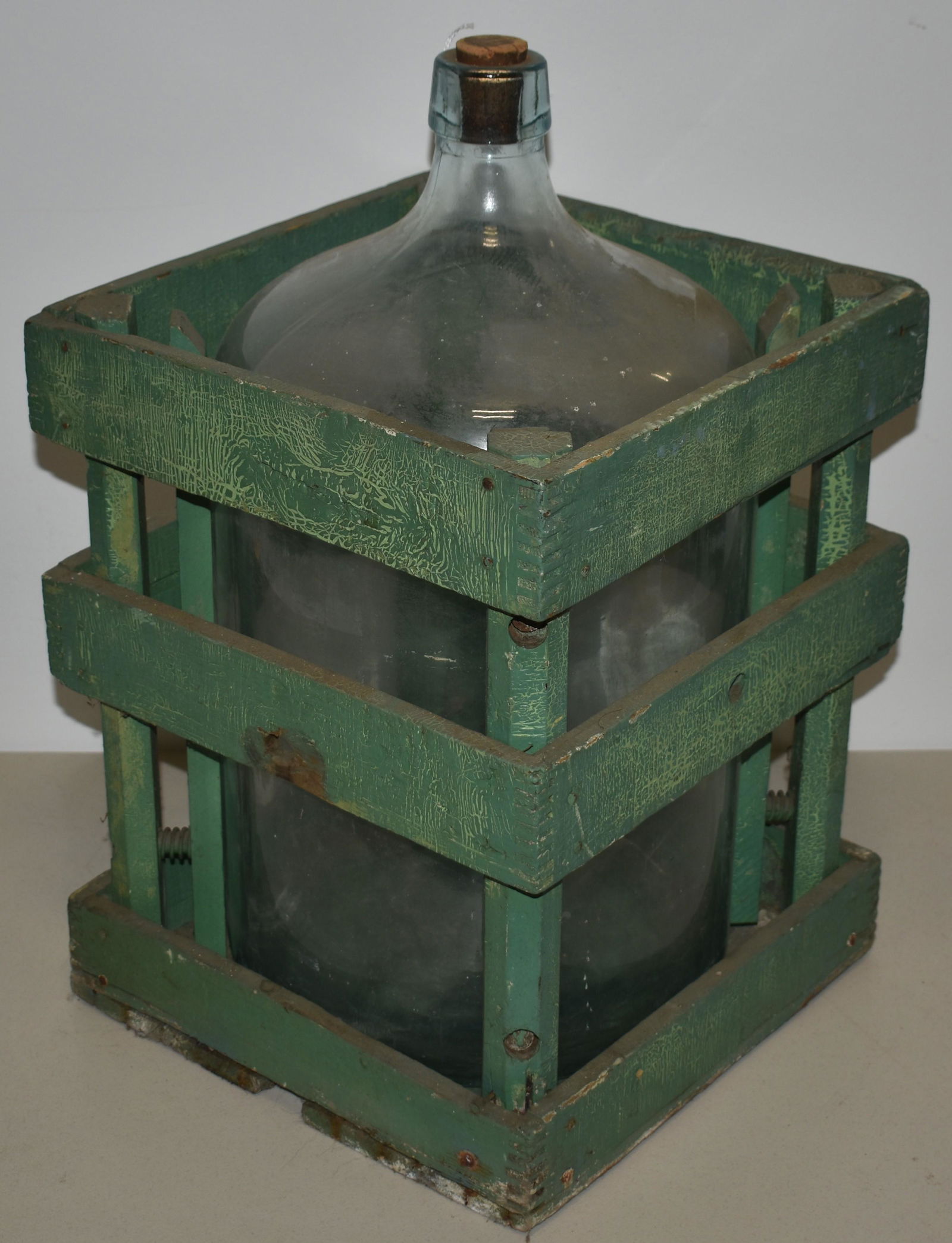 Large Crated Spring Water Bottle: LATE 19TH EARLY 20TH CENTURY AQUA CRATED SPRING WATER BOTTLE IN PAINTED CRATE IN OLD GREEN PAINT - 20 1/2 T - CRATE 12 1/4 SQUARE = IMPERFECTIONS