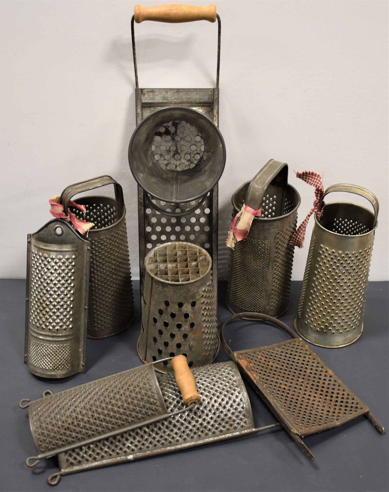Lot Tin Kitchen Graters: LOT (9) TIN KITCHEN GRATERS EARLY TO MID 20TH CENTURY - ROUND AND FLAT EXAMPLES WEAR AND IMPERFECTIONS
