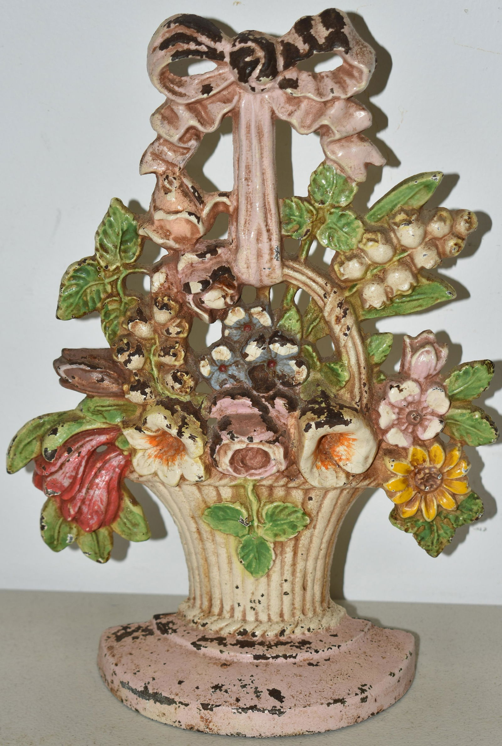 PAINTED CAST IRON BASKET OF FLOWERS DOORSTOP: 10 3/8" PAINTED CAST IRON BASKET OF FLOWERS - LILIES OF THE VALLEY DOORSTOP - HUBLEY # 189 - WEAR & LOSSES TO PAINT, OXIDATION