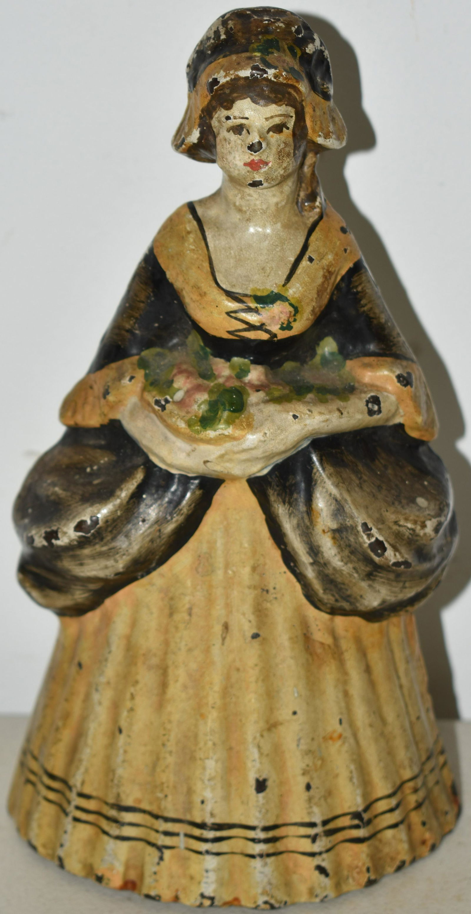 PAINTED CAST IRON WOMAN HOLDING FLOWER  DOORSTOP (1 of 2)