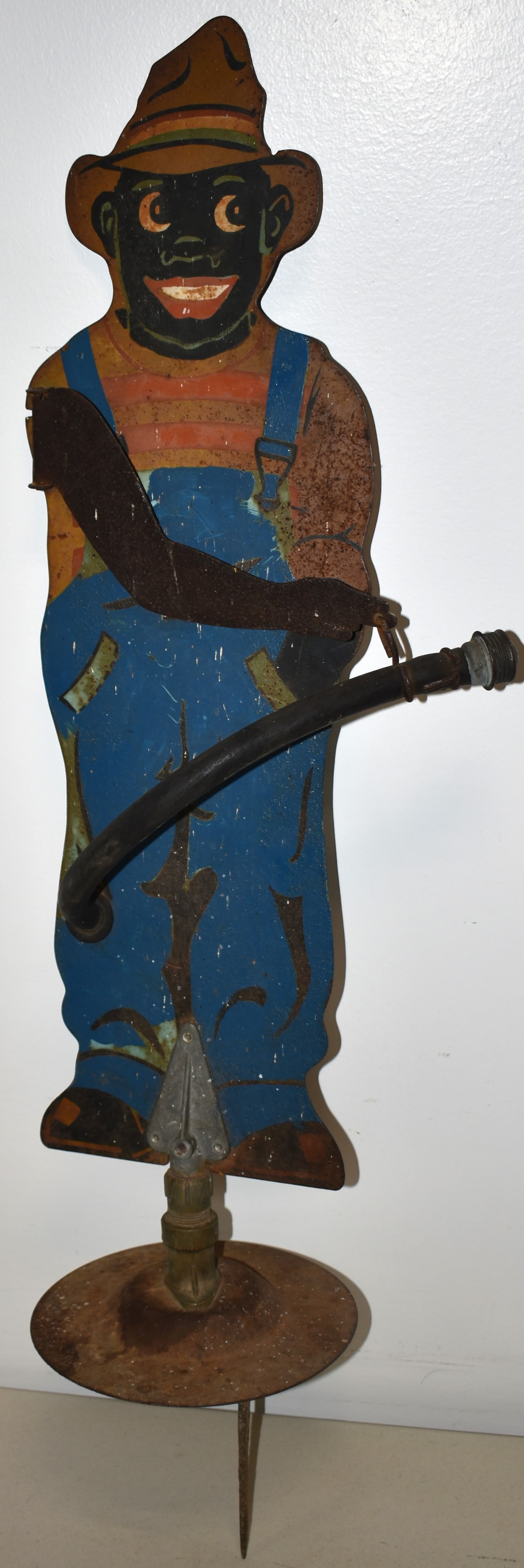 VINTAGE PAINTED METAL BLACK BOY WATER SPRINKLER: VINTAGE EARLY 20TH CENT PAINTED 2 SIDED SHEET METAL FIGURE OF A BLACK BOY IN OVERALLS WATER YARD SPINKLER - 30 1/2" T - 37 1/2" W/ SPIKE FOR GROUND - 2 SIDED FRONT & BACK - OXIDATION, WEAR & IMPERFECT
