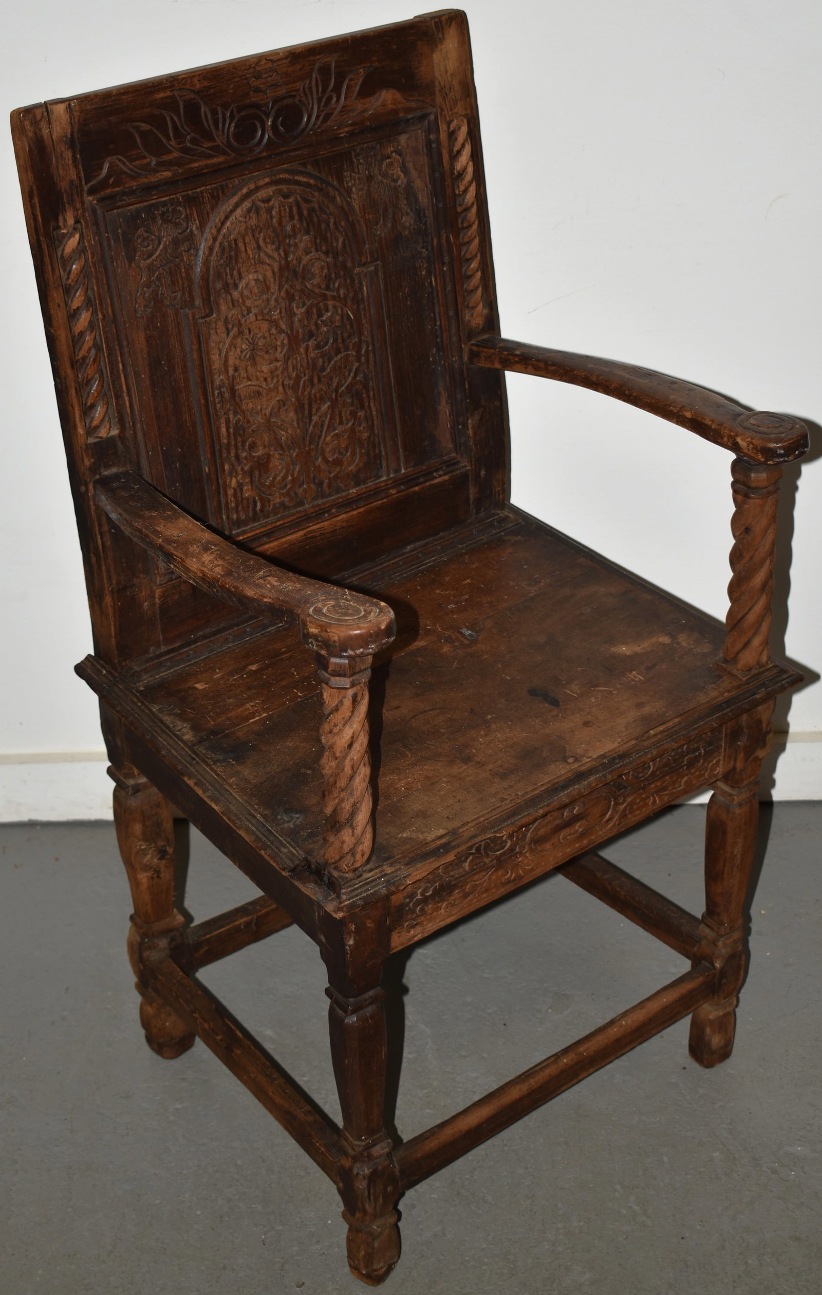EARLY CARVED OAK ENGLISH ARMCHAIR: EARLY ENGLISH WAINSCOT ARMCHAIR - 39" T X 20 1/2" W X 16 1/2" D - WEAR, LOSSES & IMPERFECTIONS