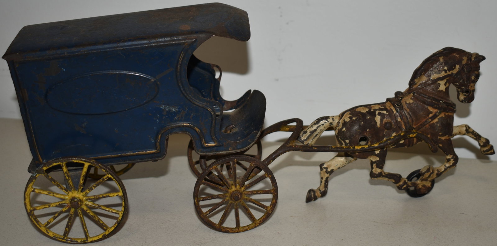 WILKINS PRESSED STEEL DELIVERY WAGON: LATE 19TH EARLY 20TH CENT WILKINS HORSE DRAWN DELIVERY WAGON - CAST IRON HORSE W/ PRESSED BLUE STEEL DELIVERY WAGON - 14 1/2" L - WEAR, LOSSES TO PAINT, OXIDATION & IMPERFECTIONS