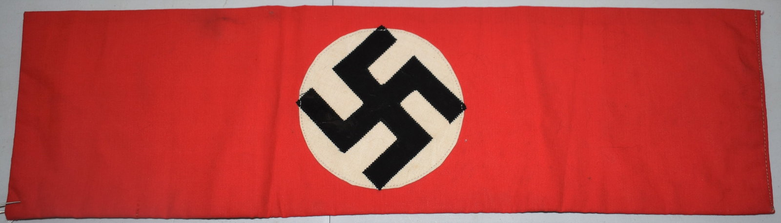 WWII NAZI GERMAN ARMBAND W/ SWASTIKA INSIGNIA: RED TEXTILE ARMBAND W/ BLACK & WHITE NAZI INSIGNIA (SWASTIKA) - 16 1/2" X 4 3/4"