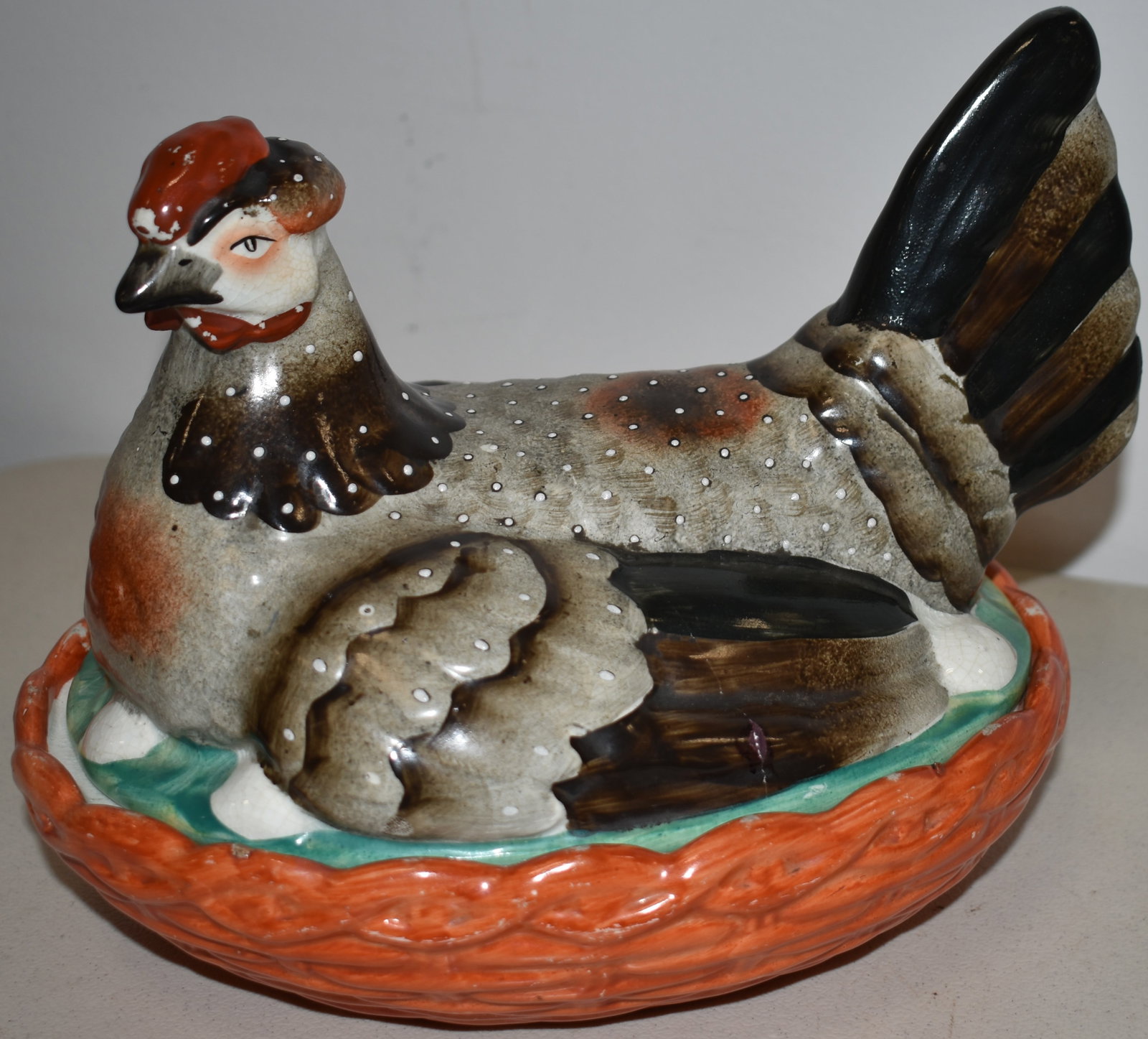 STAFFORDSHIRE HEN ON NEST: 19TH CENT STAFFORDSHIRE HEN ON NEST - 9 1/4" L X 7 1/4" W X 7 1/4" T - HAIRLINE & SM. CHIP TOP - CRAZING BASE, STAINS, IMPERFECTIONS, WEAR TO PAINT & TIGHT HAIRLINE - IMPERFECTIONS