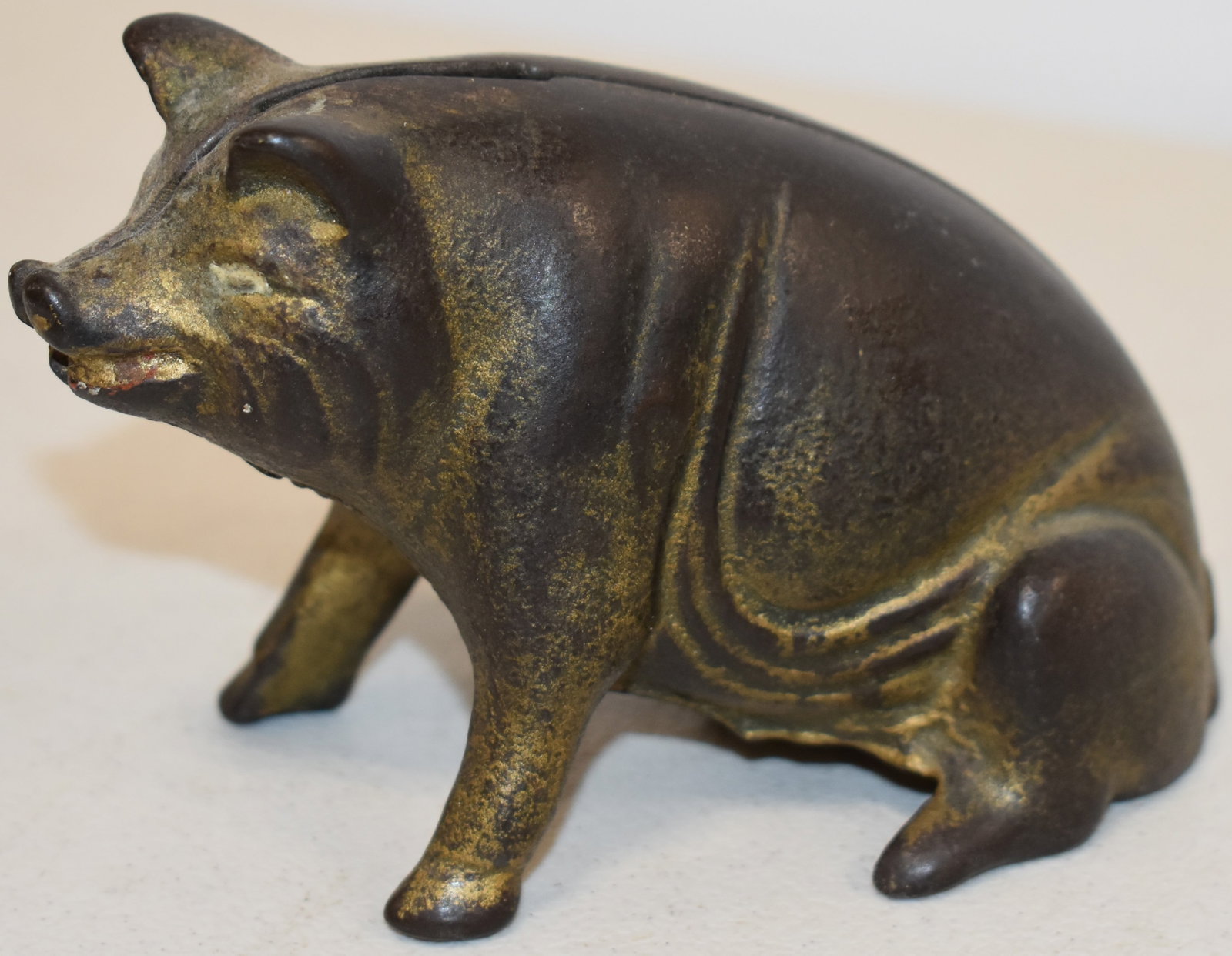 CAST IRON SITTING PIG STILL BANK: VINTAGE PAINTED CAST IRON FIGURAL SITTING PIG STILL BANK - 4 1/2" L X 2 7/8" T - WEAR & LOSSES TO PAINT - REPLACED SCREEN & IMPERFECTIONS