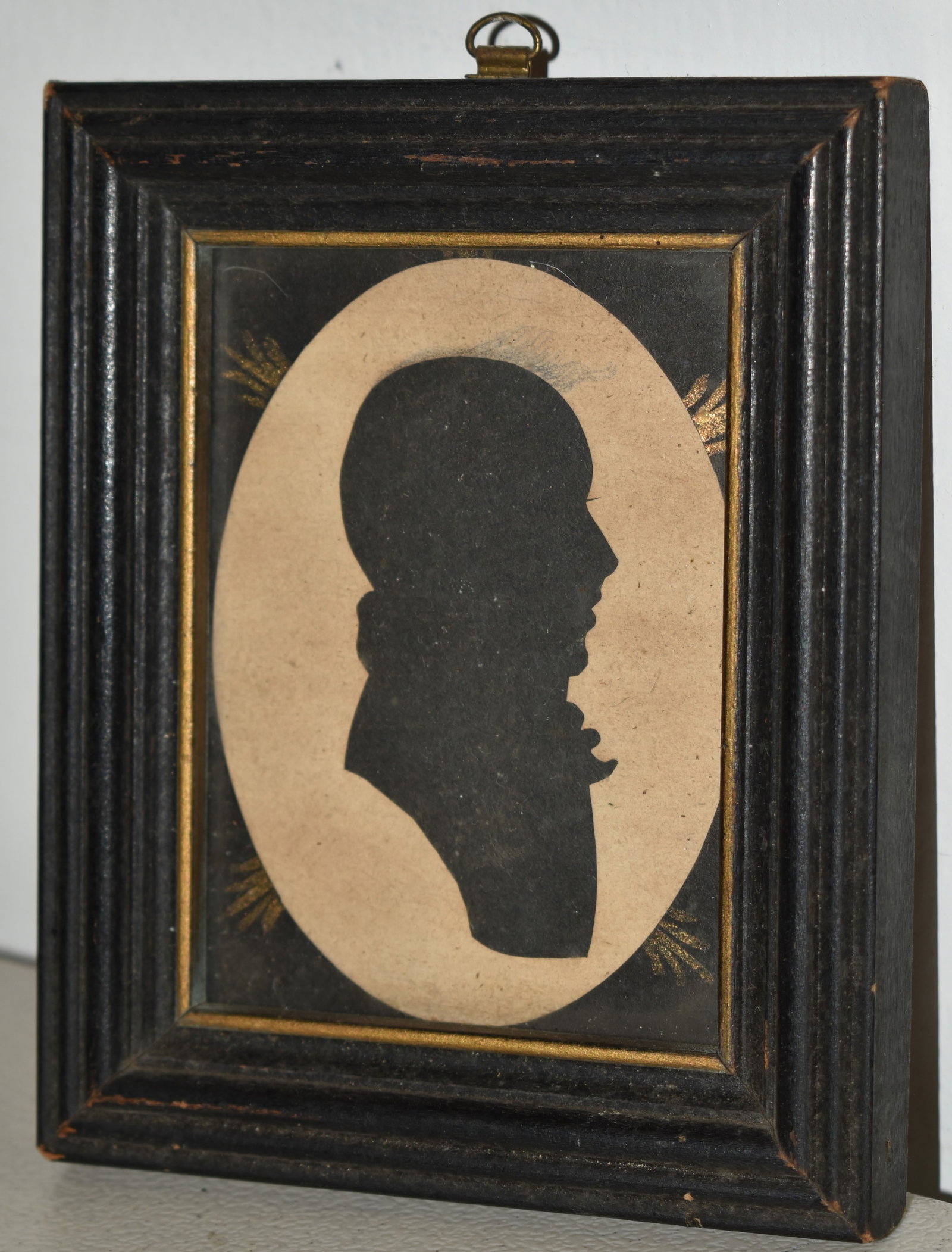 19TH CENT WATERCOLOR SILHOUETTE OF A GENTLEMAN: 19TH CENT FRAMED WATERCOLOR SILHOUETTE BUST OF GENTLEMAN - OVAL W. BLACK BOARDER W/ GOLD HIGHLIGHTS IN A BLACK MOLDED FRAME - 3 1/2" X 2 1/2" SIGHT - TONING & IMPERFECTIONS
