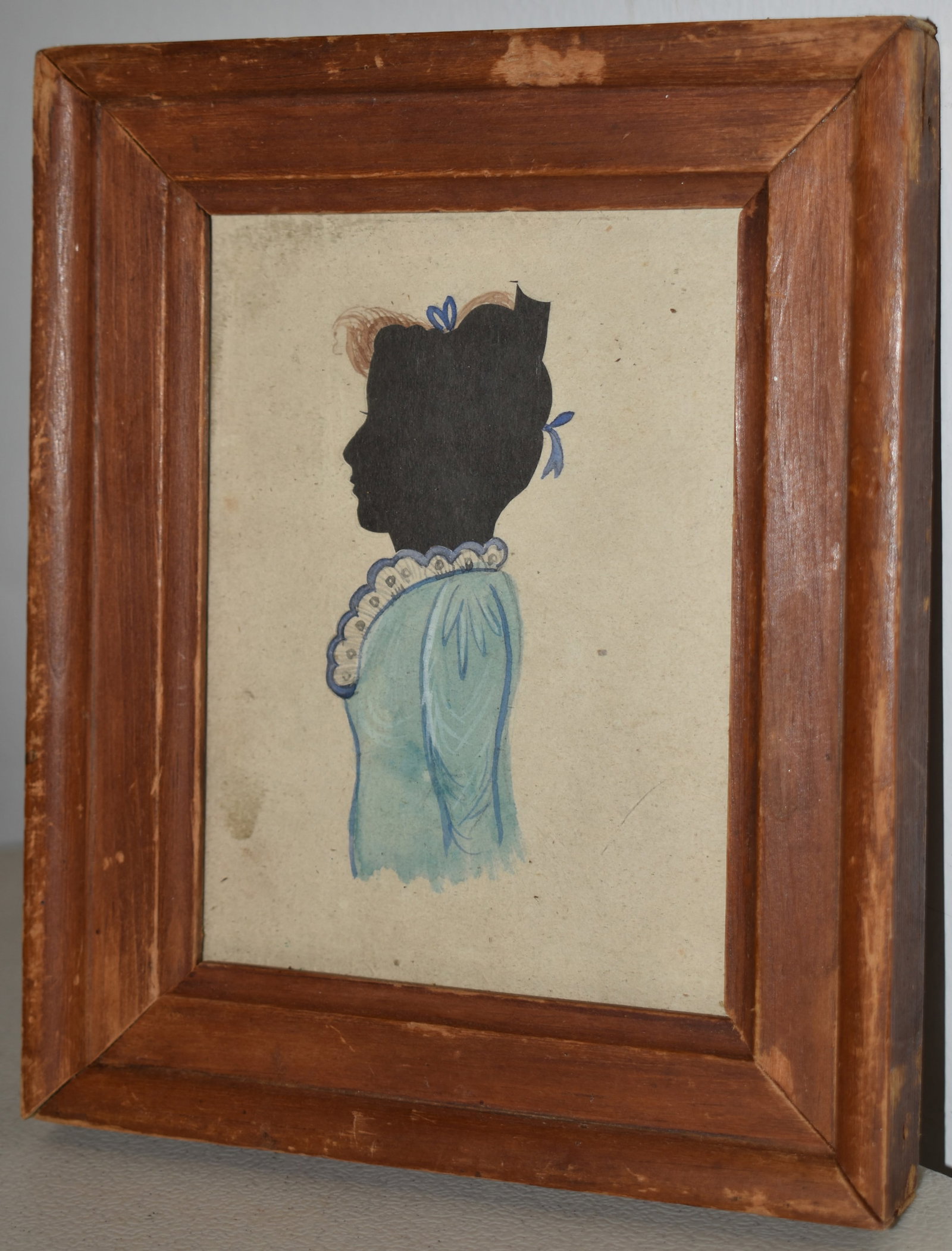 19TH CENT WATERCOLOR & CUT SILHOUETTE OF A LADY: 19TH CENT FRAMED WATERCOLOR & CUT SILHOUETTE OF A 3/4 LENGTH YOUNG LADY IN BLUE DRESS W/ BLUE & WHITE LACY COLLAR - 4 3/4" X 3 1/2" - TONING & IMPERFECTIONS