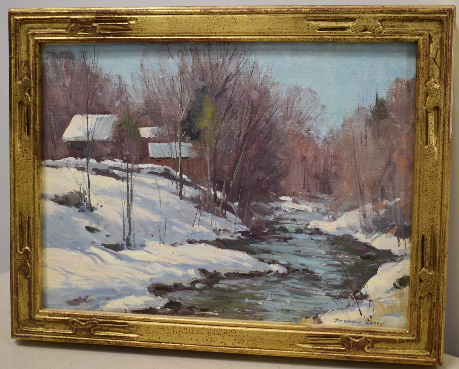 BERNARD COREY WINTER SCENE OIL PAINTING: 20TH CENT OIL PAINTING ON CANVAS BAORD - HOUSE BY A STREAM WINTER SCENE - SIGNED BERNARD COREY LOWER RIGHT - 8 1/2" X 11 1/2" SIGHT - IN A GILT MOLDED WOODEN FRAME