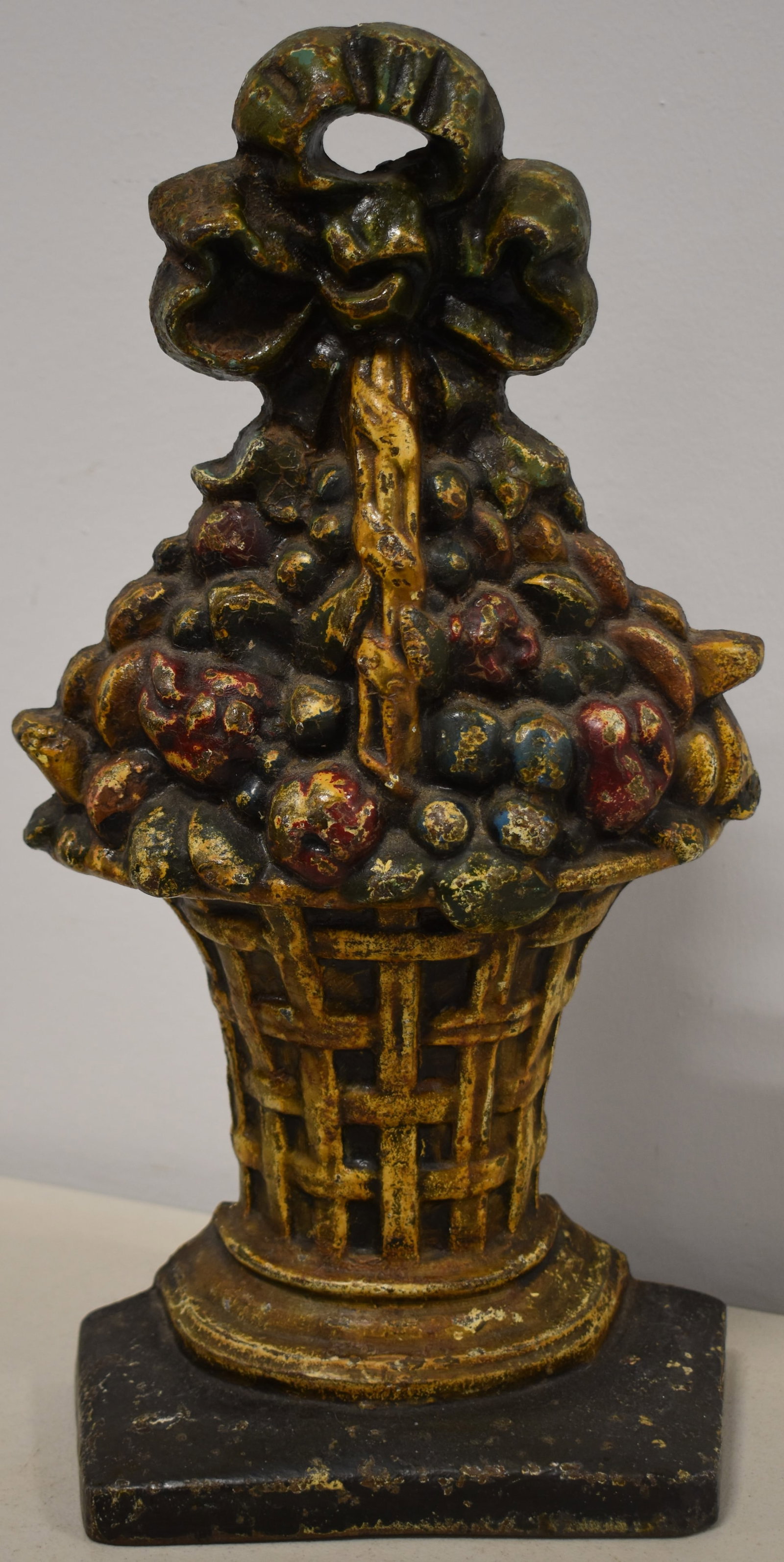 15 1/2" CAST IRON BASKET OF FRUIT DOORSTOP: PAINTED CAST IRON BASKET OF FRUIT DOORSTOP W/ RIBBON - HUBLEY - WEAR, MINOR PAINT LOSSES & IMPERFECTIONS