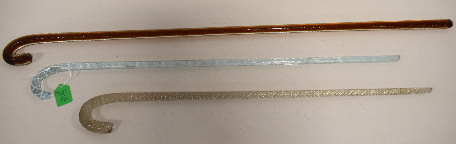 (3) 19TH CENT WHIMSICAL BLOWN GLASS CANES: LOT (3) 19TH CENT WHIMSICAL BLOWN GLASS CANES - INCLUDES 24" CLEAR TWISTED CANE - 34 1/2" CLEAR OVER AMBER CANE & 26 3/4" AQUA WHITE OPALESCENT SWIRLED CANDY CANE DESIGN - WEAR & IMPERFECTIONS