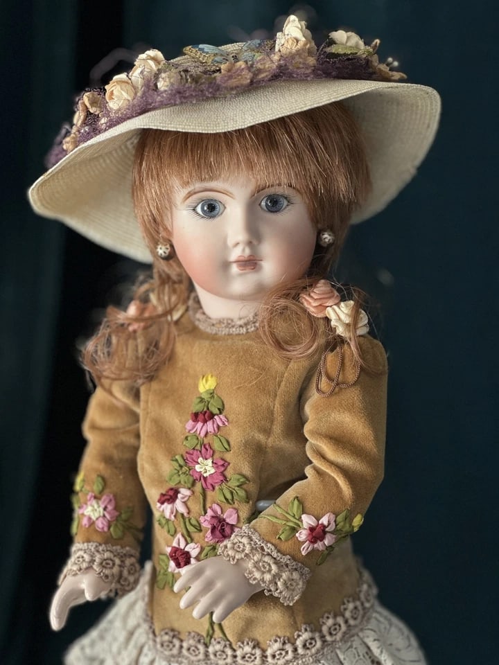 Vintage Reproduction of Antique French Jumeau 16 1/2" Doll: Gorgeous reproduction of antique French Jumeau doll!She is about 16 1/2” tall; porcelain head and vernon seeley body. Stationary blue eyes. Professionally done face painting. Synthetic hair wig;