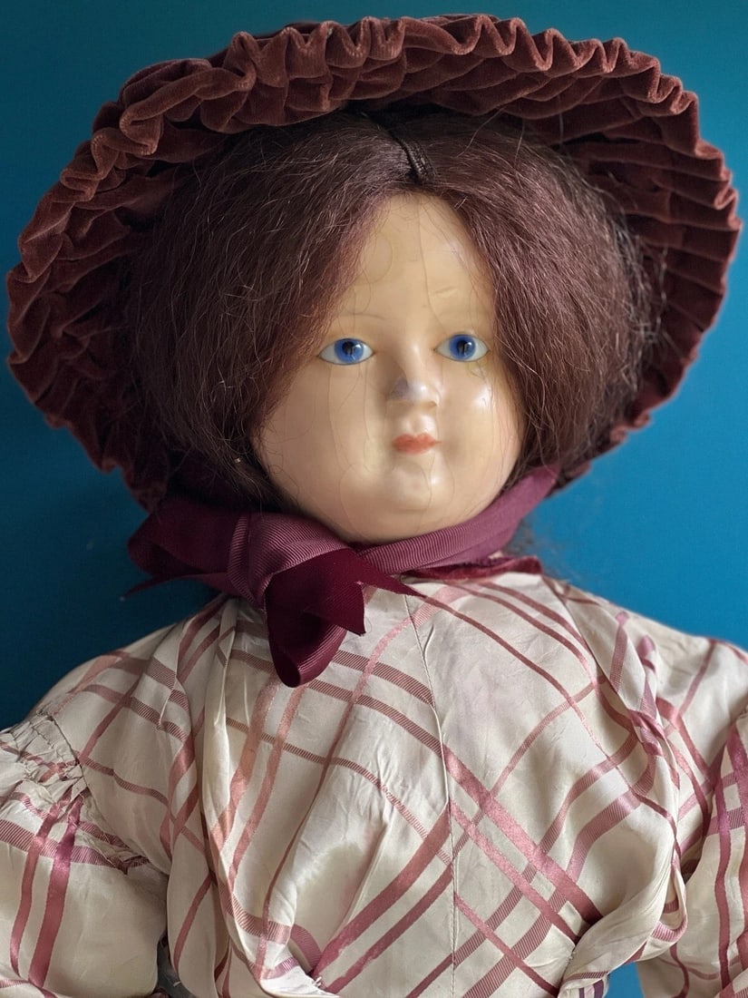 Large Antique German 30" Wax Over Papier Mache Doll: Very old and relatively well preserved doll. The doll has stationary glass eyes. The wax is cracked and one piece is missing. Some missing wax is on the nose as well. Wear to the shoulder plate. The w