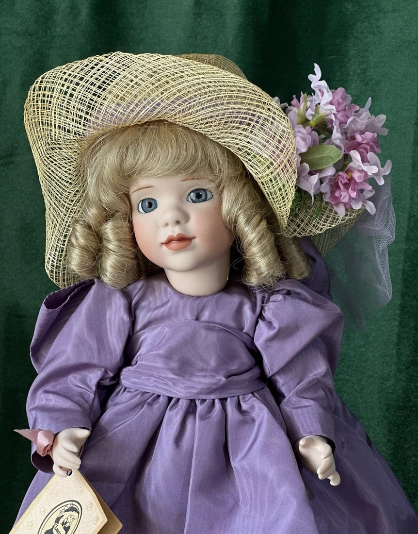 Wendy Lawton "Lavender Blue" 13" Porcelain Doll Box/Tag/COA: Porcelain 13" doll by Wendy Lawton.She is all porcelain.Her name is "Lavender Blue."Comes with tag, COA and boxStand is not included. Wear and tear is present to the box. Unsure if missing any accesso