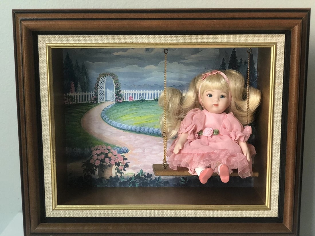 NIB Marie Osmond Springtime Splendor 5" Doll In Open Shadow Box: Beautiful porcelain 5" displayed sitting on the swing in a shadow box. Frame measures 11" x 9" x 3". Doll was removed from her box for pictures only. Comes with COA , tag and original bracelet by Mari
