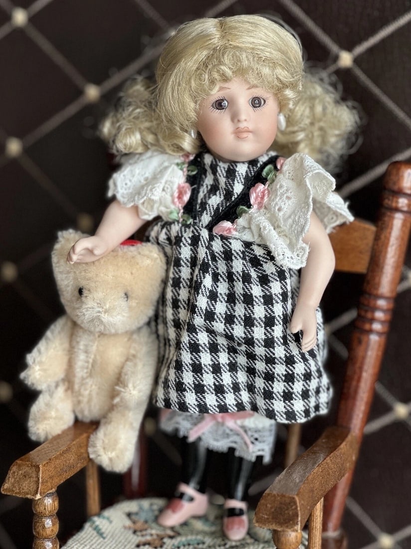 Porcelain Reproduction of Antique German Simon Halbig Mignonette Doll LE 2500: Very sweet little 7.5" tall doll. All the parts of the doll are porcelain. Good stringing to the doll. No damage. The doll is overall in good condition, with possible just light wear. The doll has pie
