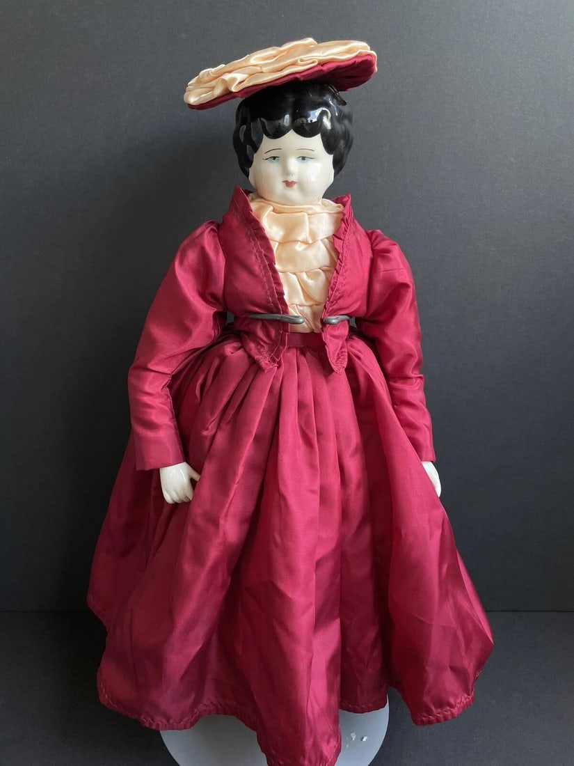 Vintage 18" Reproduction of Antique German Lowbrow China Doll: Very sweet vintage reproduction with typical crazing to china parts. The doll is not a professional reproduction and has paint and mold imperfections. Left hand has a chip or mold defect. The body is