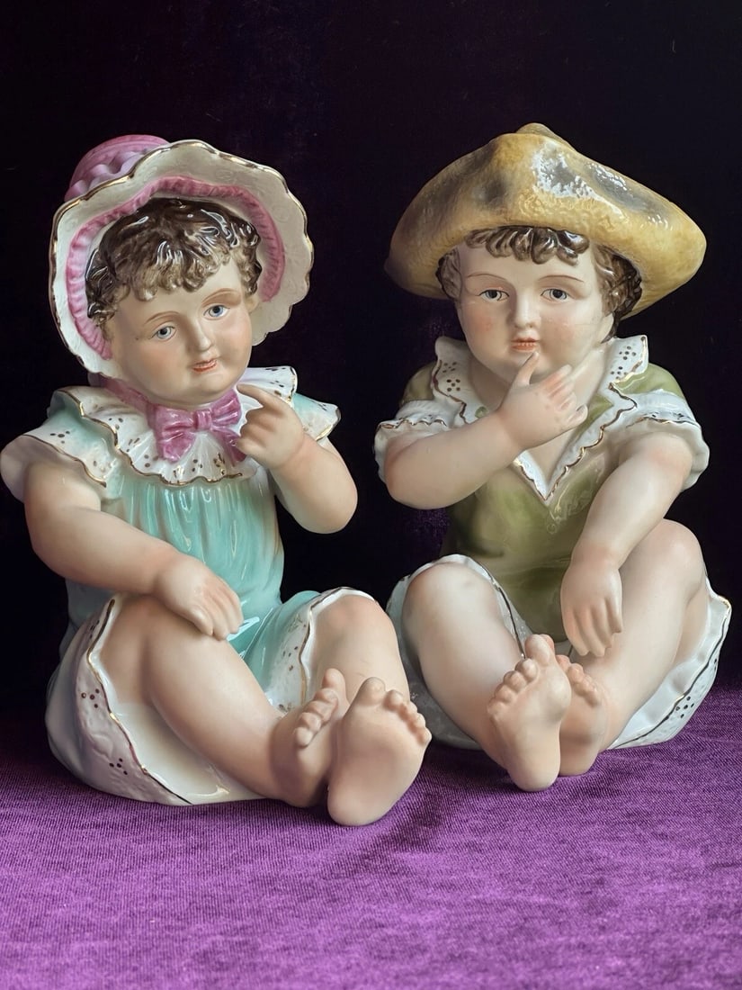 Lot of 2 Vintage Japanese or German Porcelain Piano Babies Figurines: Both are sweet and both are approximately 7" tall. They are marked as shown on the photos. The boy is damaged. Possibly was glued. The girl is in good shape. Please refer to the pictures for more deta
